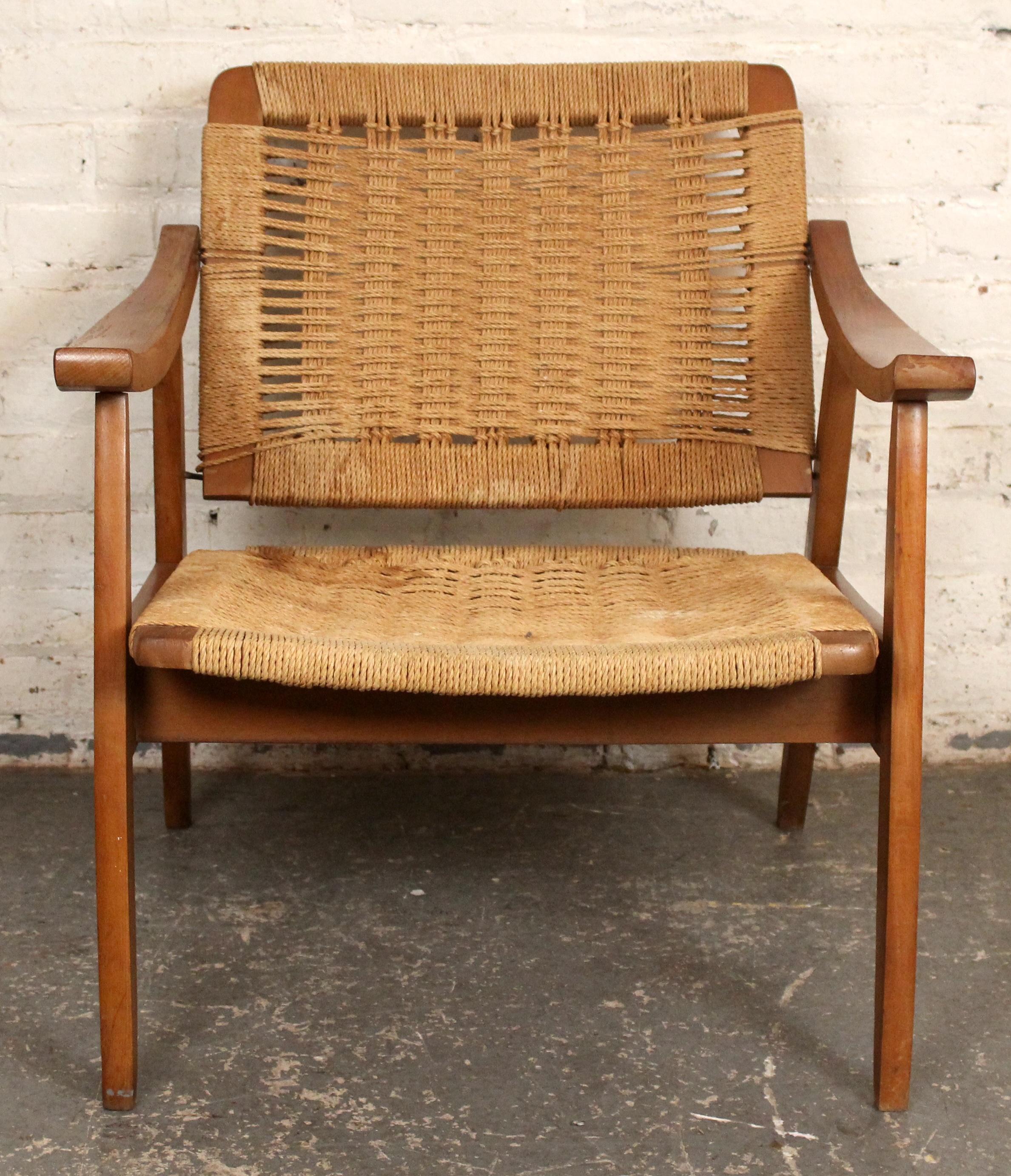 A sculptural armchair in the style of Hans Wegner, showcasing a solid wood frame and handwoven rope seat and back. This Scandinavian modern design combines comfort, craftsmanship, and portability—ideal for both everyday use and stylish