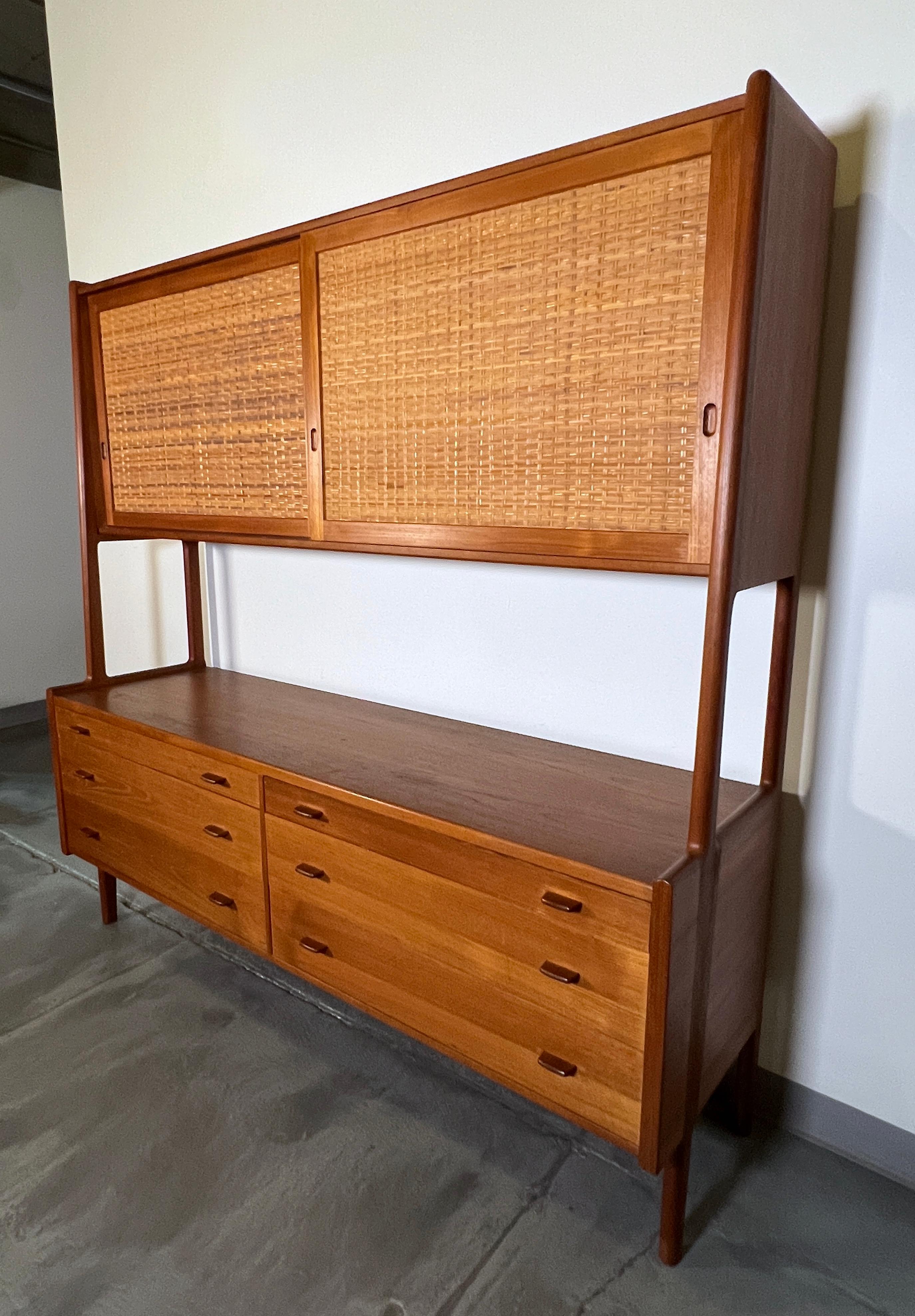 Sideboard credenza in teak with six drawers topped by a cabinet with cane door fronts, designed by Hans Wegner for Ry Møbler, circa 1960s.
