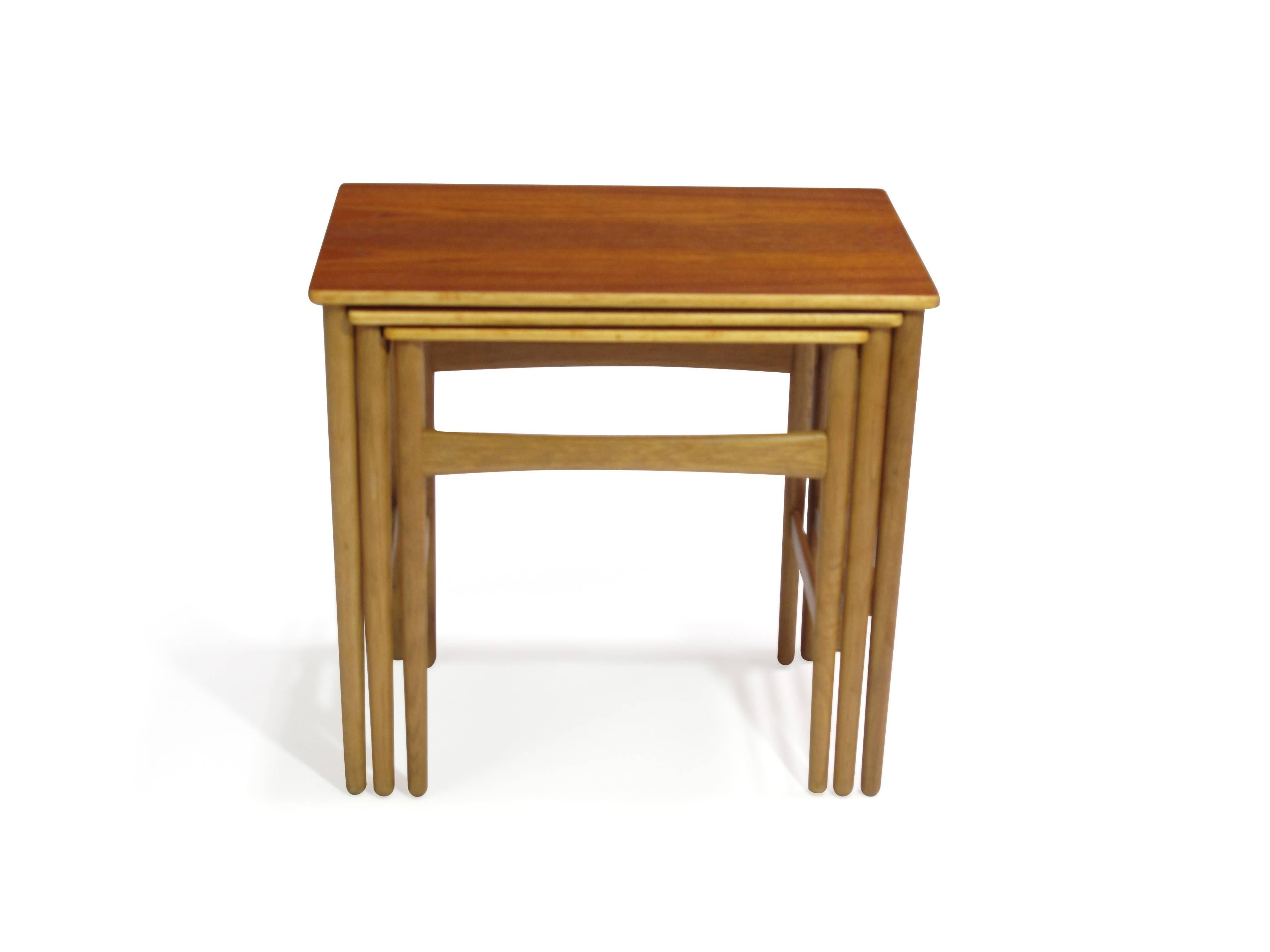 Hans Wegner Danish teak and oak nesting tables finely restored and in excellent condition. Stamped.
