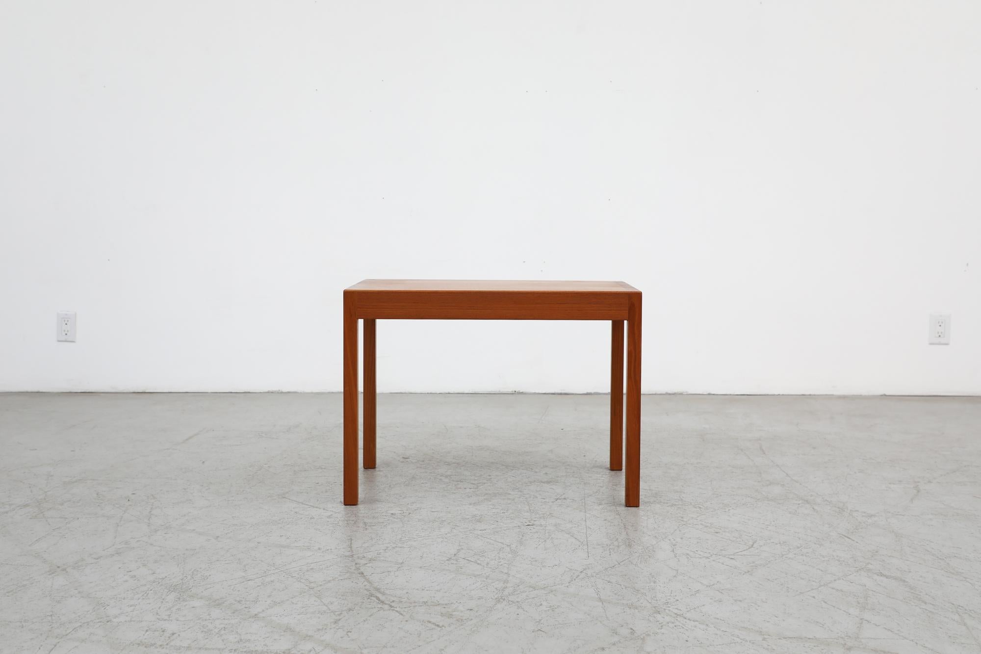 Gorgeous Danish Mid-Century Modern teak side table by acclaimed designer Hans J. Wegner for Andreas Tuck. Sparse and minimalist design with clean and simple lines add a timelessness to this piece. Manufacturer's stamp on bottom. In original