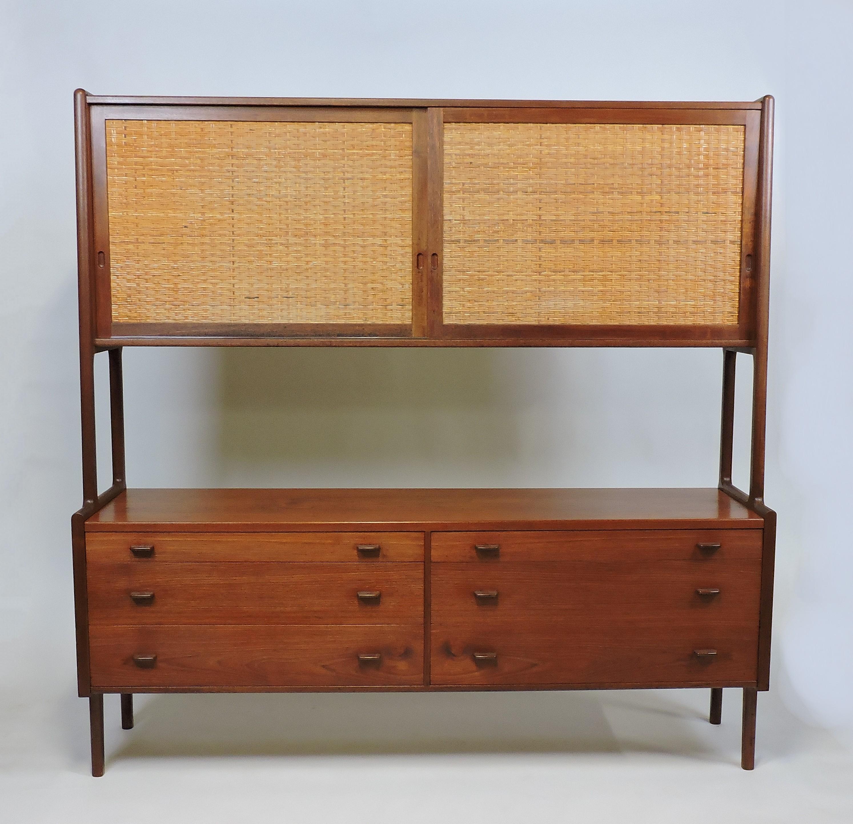 Beautiful two-tier credenza in teak designed by Hans Wegner and manufactured in Denmark by Ry Mobler. This cabinet has six drawers and two sliding doors with cane fronts above. Pictured with four adjustable shelves, a fifth is available. Stamped
