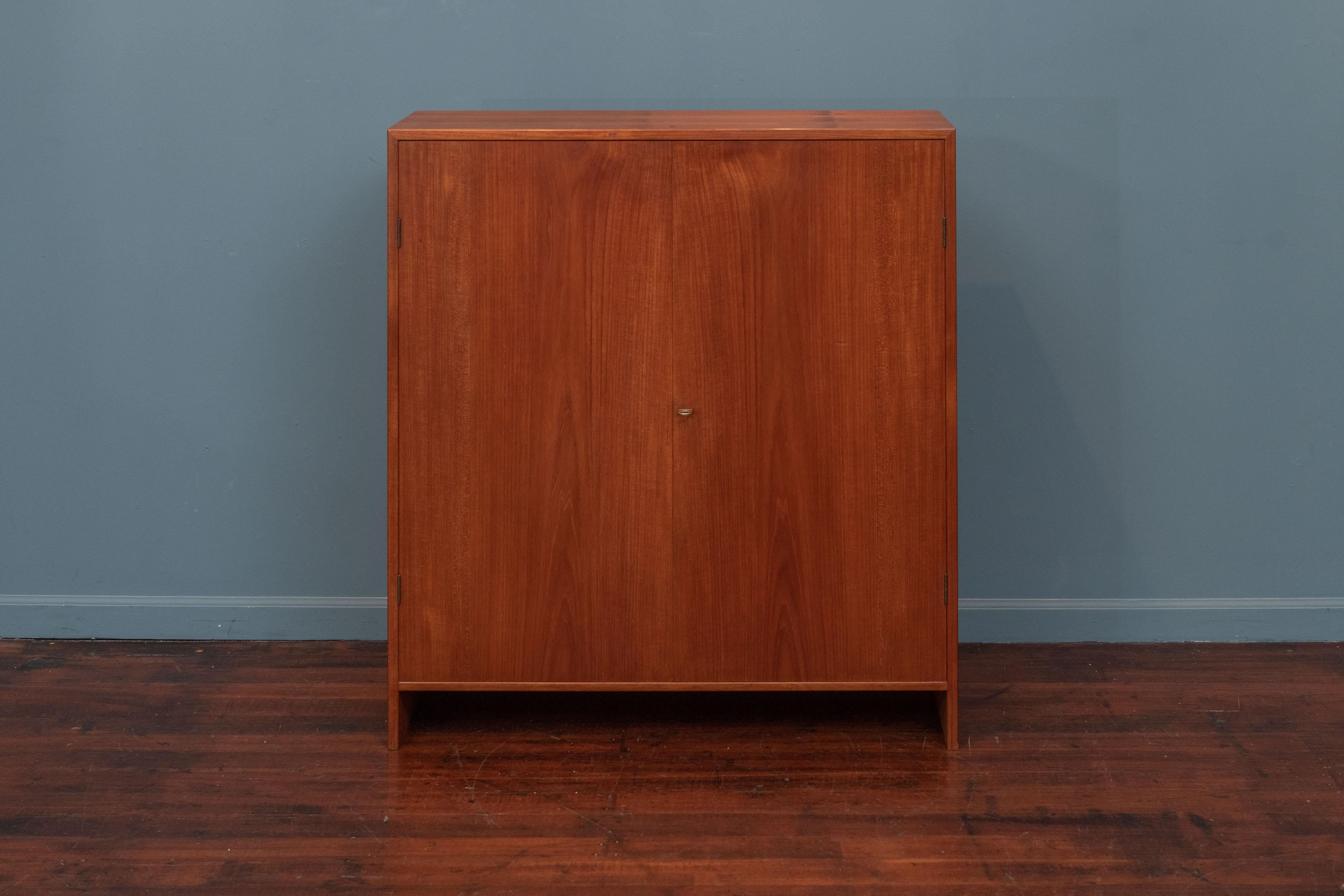 Hans Wegner design two door teak case with pine interior with a brass ring latch. Produced by RY Mobler, Denmark in very good original condition.