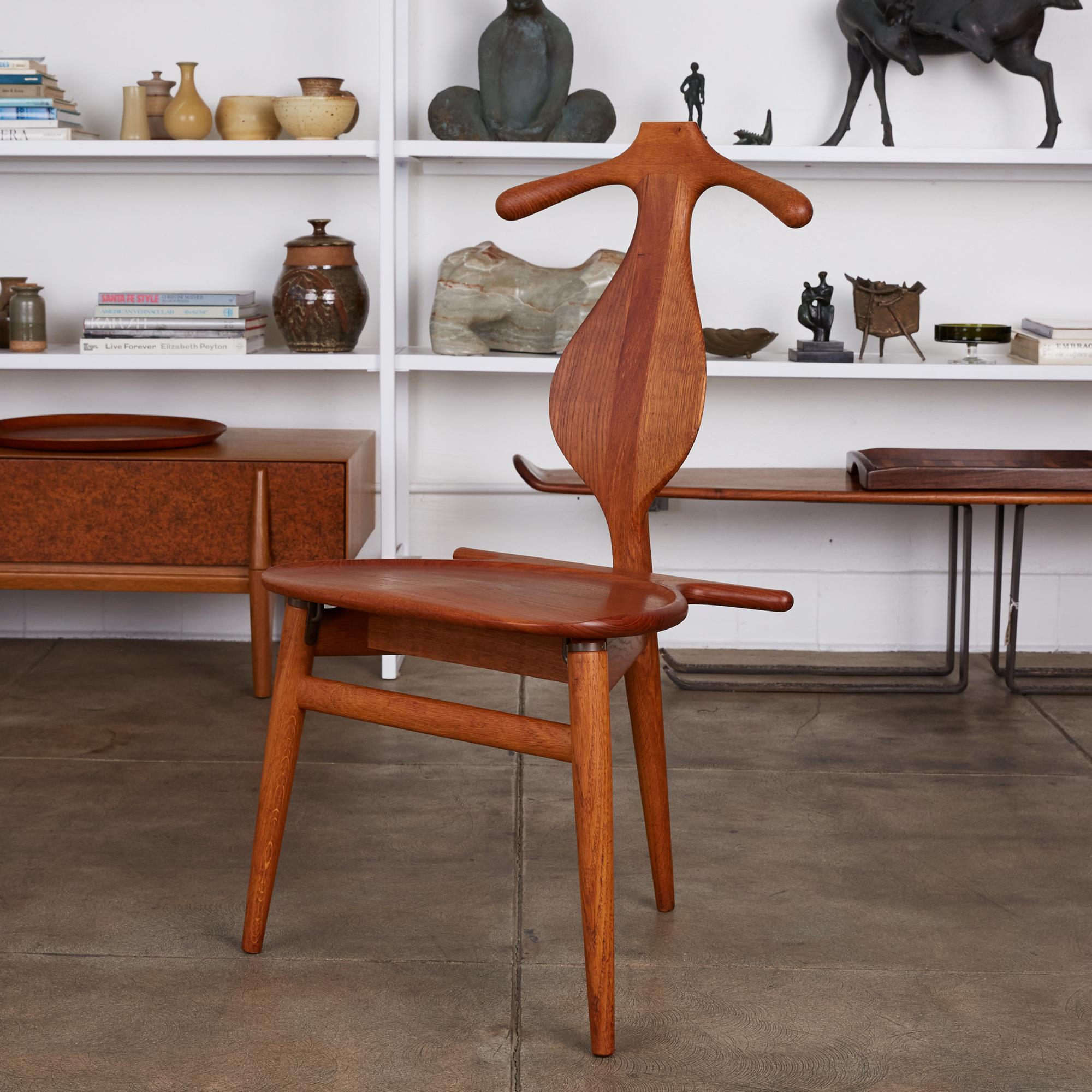 The iconic three legged valet chair designed by Hans J. Wegner for Johannes Hansen. The original four legged piece was conceived by Wegner after a discussion with his colleagues about issues with how to fold one’s clothing at the end of the day. He