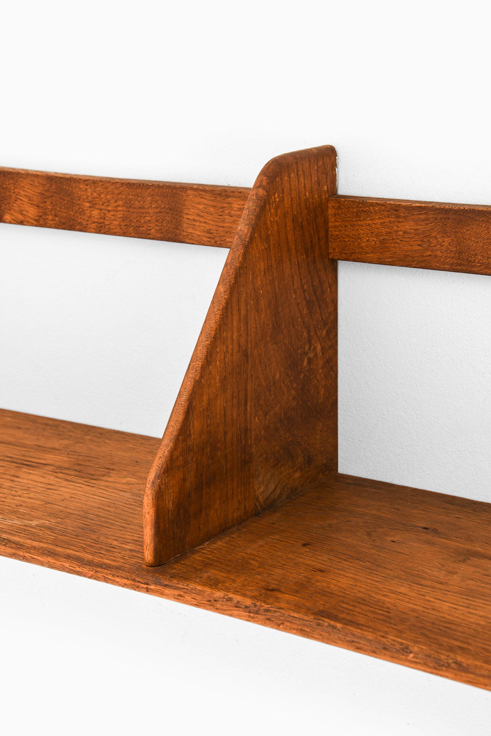 Wall mounted shelf designed by Hans Wegner. Produced by Ry Møbler in Denmark.