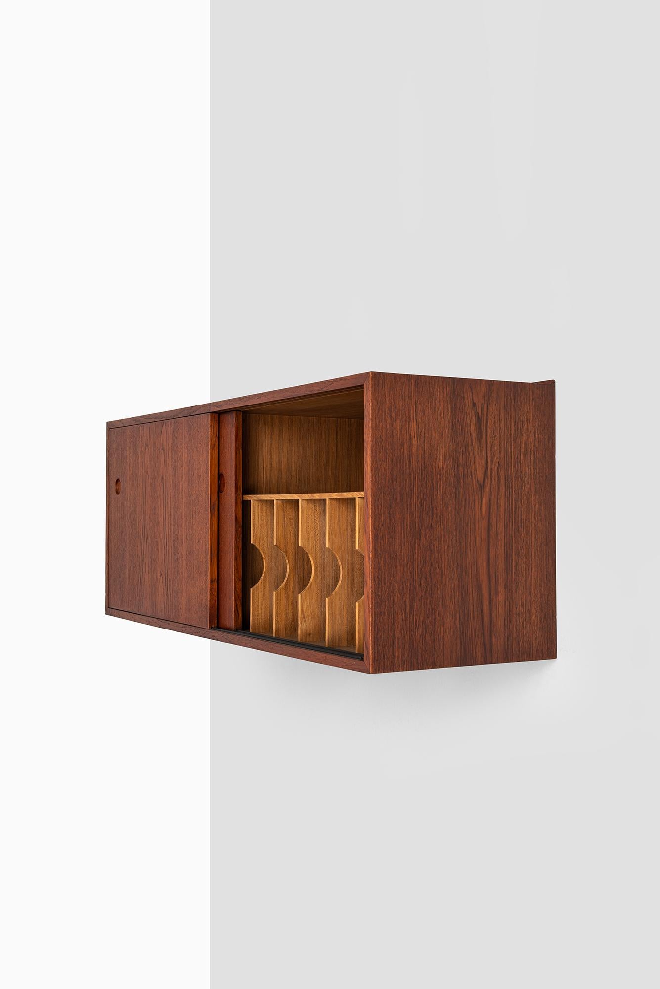 Rare wall-mounted sideboard designed by Hans Wegner. Produced by cabinetmaker Johannes Hansen in Denmark. Built in record player and storage compartments.