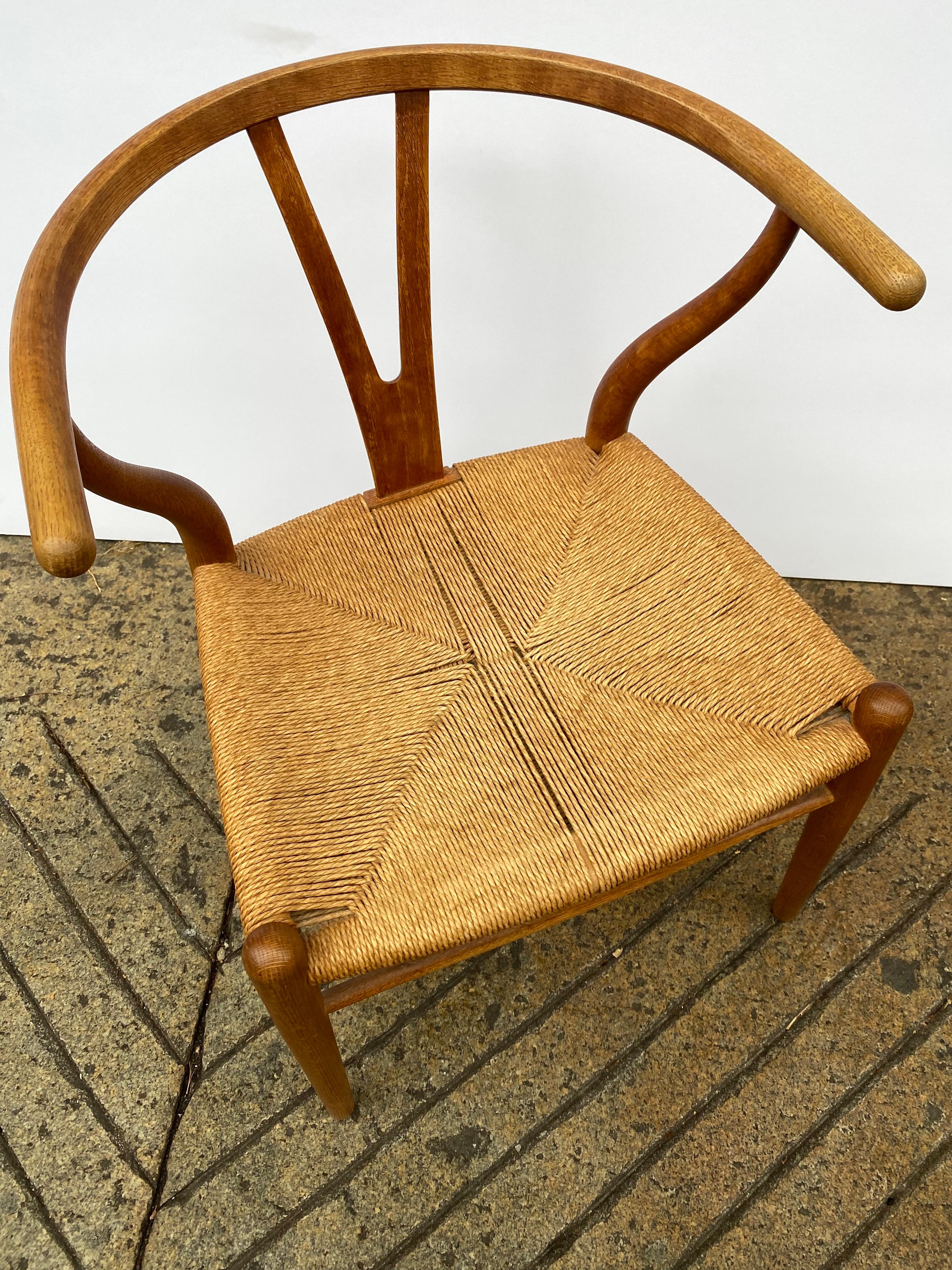Hans Wegner Wishbone dining chair in oak. Nice early example signed underside. Classic design perfect for so many spots! All original!