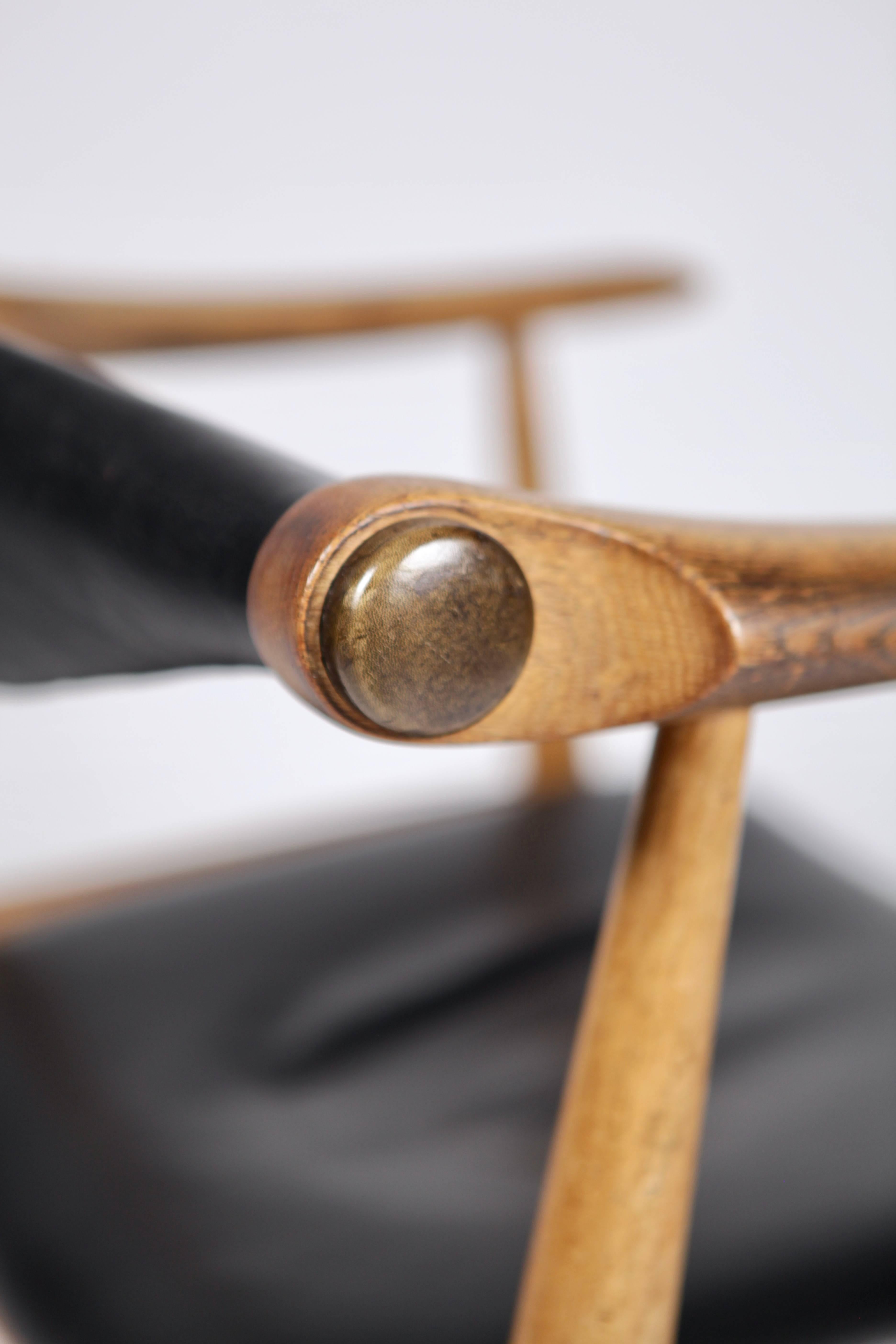 Armchair, model CH34, designed by Hans J. Wegner and manufactured by Carl Hansen & Son in 1959, Denmark.
Solid oak and original black leather.
Rare early version in good condition and with great patina.
Signed to the underside.
     