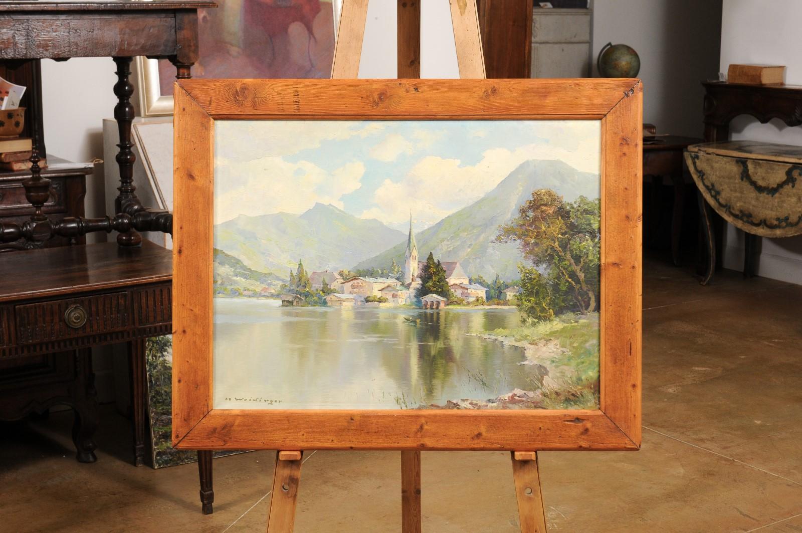 A German oil on canvas mounted on board landscape painting by artist Hans Weidinger from the Mid-20th Century, depicting the town of Tegernsee located in the Bavarian Alps. Created in Germany during the second quarter of the 20th Century, this oil