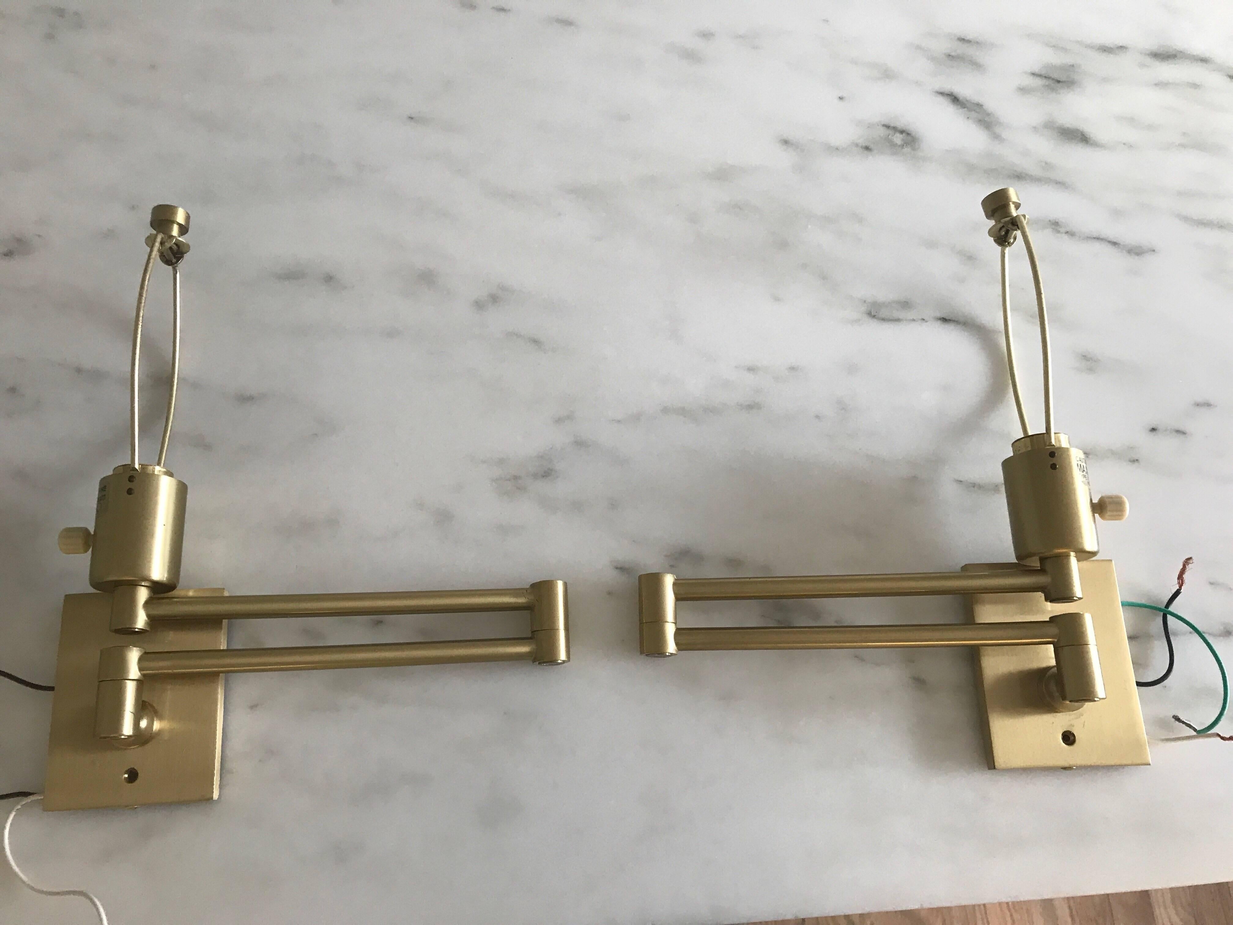 Hansen brass swing arm lamps for Hinson & co. Stamped Hansen lamps, New York.
Brass swing arm lamps include two shades and finials. Some wear to finish at edge of back plate. Very good and working condition.
13.5