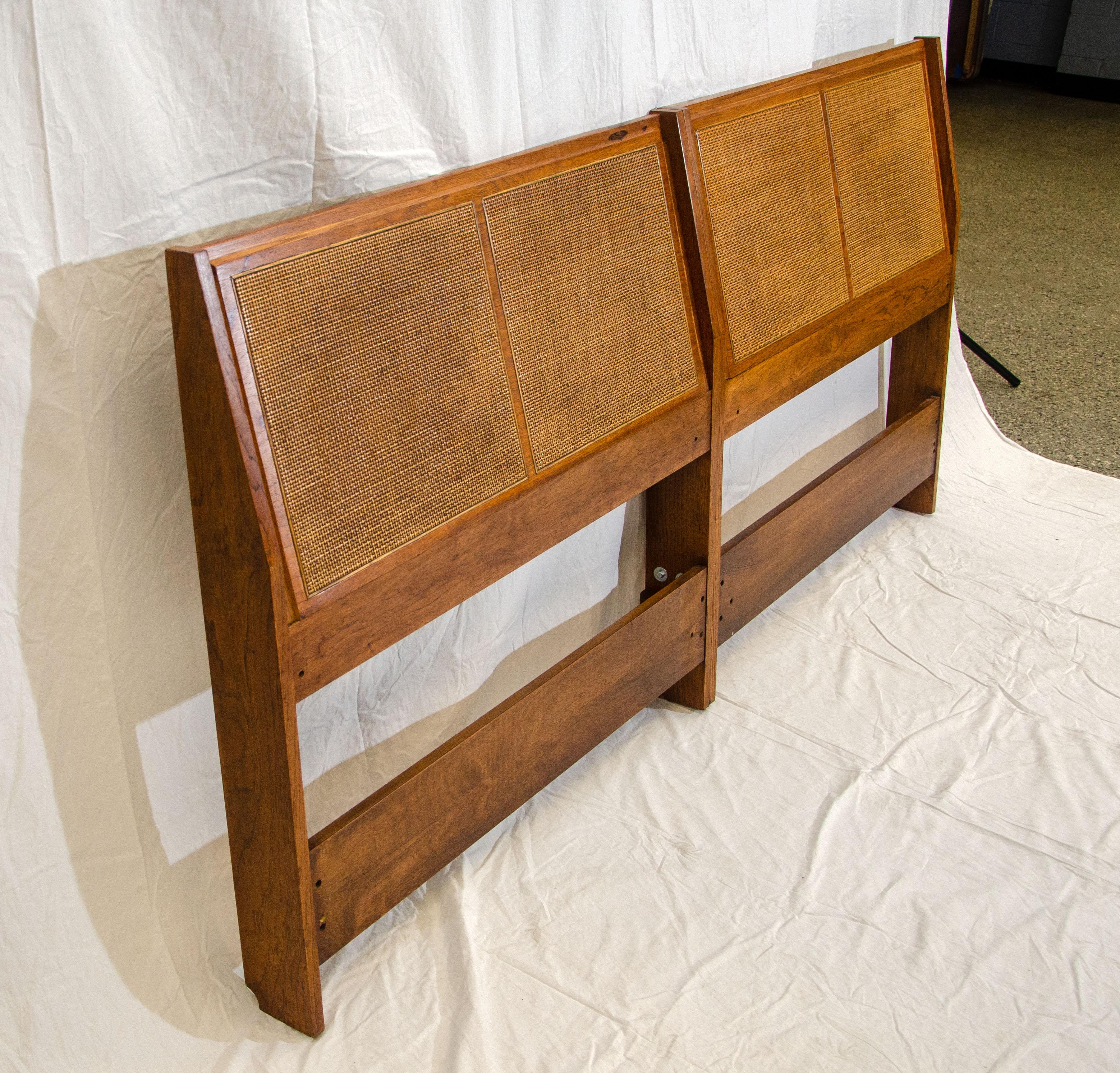 This original pair of twin size headboards were joined together to be used as a king size headboard. The headboard can also be split back into twin headboards by removing five bolts, a very versatile piece of furniture. The caning is original and in