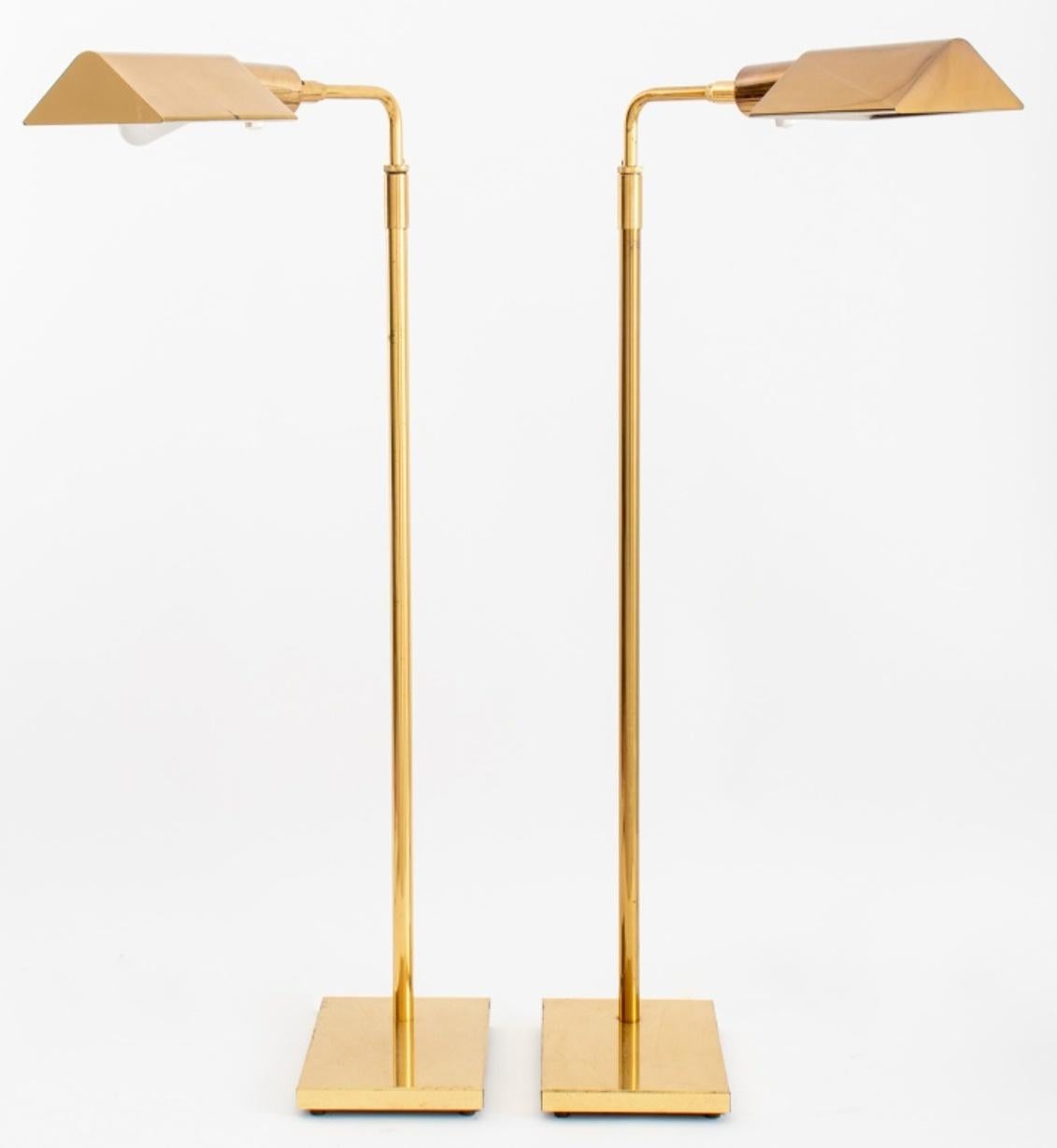 Pair of brass floor lamps in the manner of Hansen, with triangular light shades on an adjustable goose neck, above rectangular bases.

Dimensions:   35