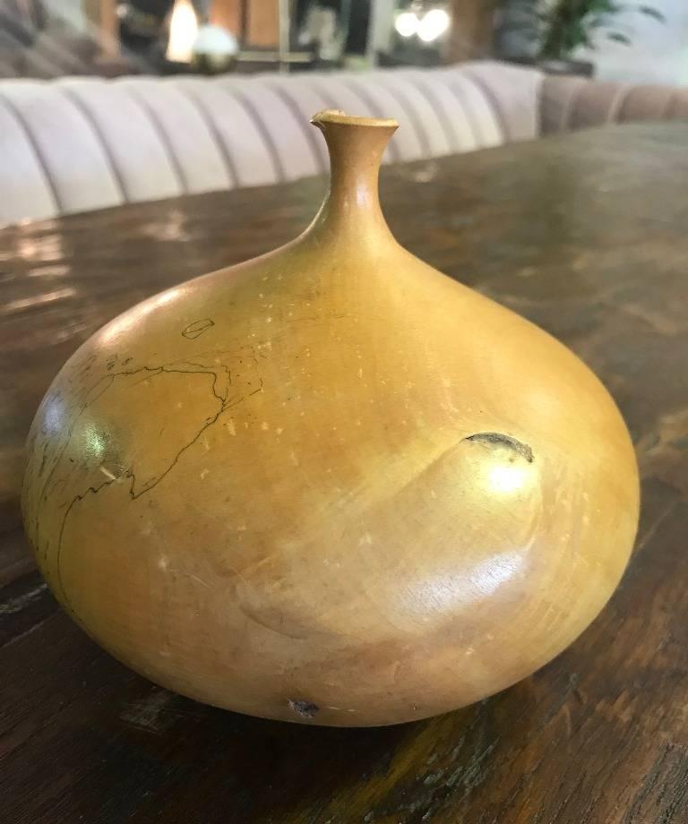 A very unique piece by master wood sculptor/artist Hap Sakwa, widely considered a leader of the wood turning movement in the late 1970s and early 1980s. This piece is made of burled buckeye wood and is solid and wonderfully turned with one large