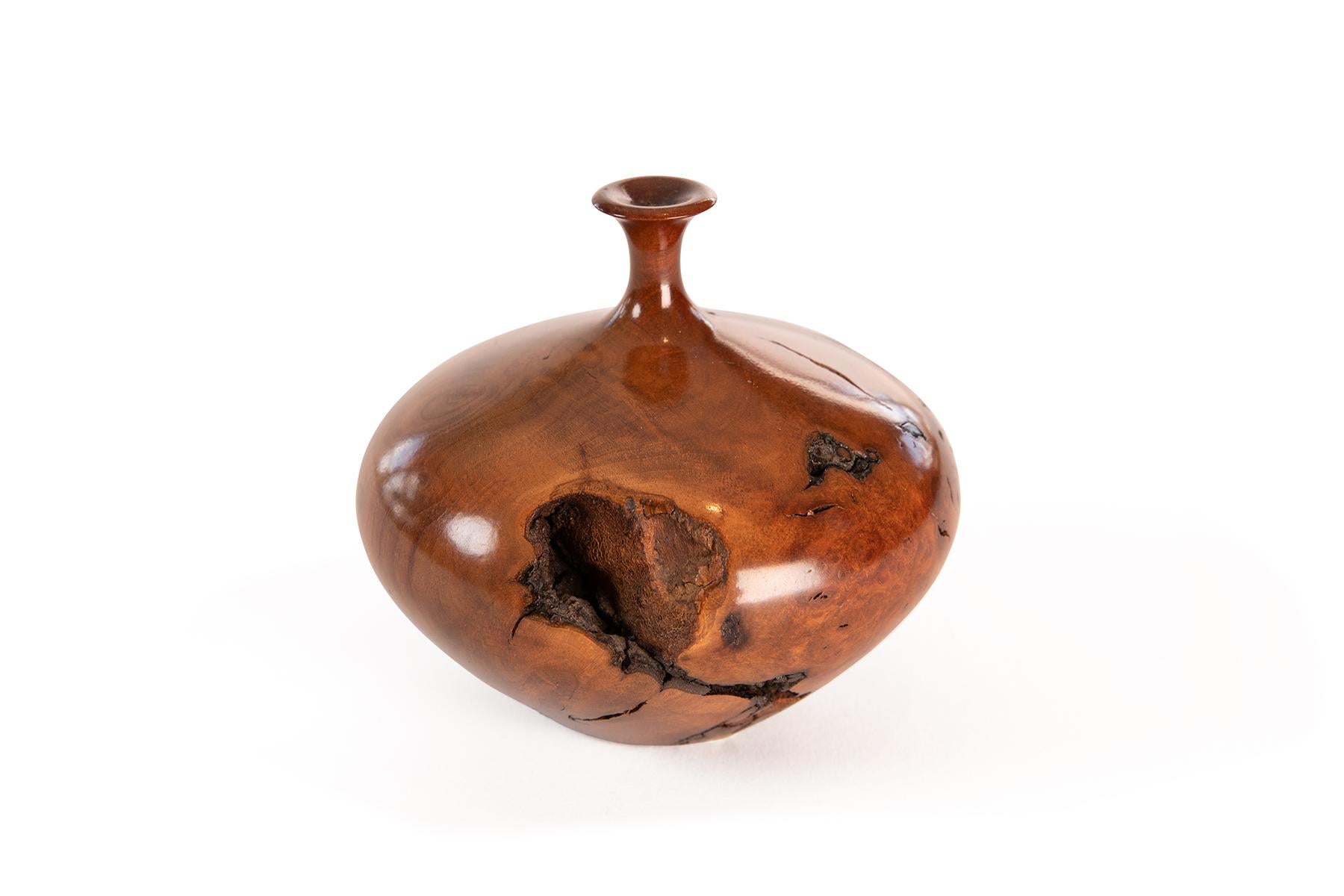 Small, elegant turned burled walnut vessel by craftsman Hap Sakwa incorporating the imperfections of the wood as part of the of the sculptural quality of the piece.