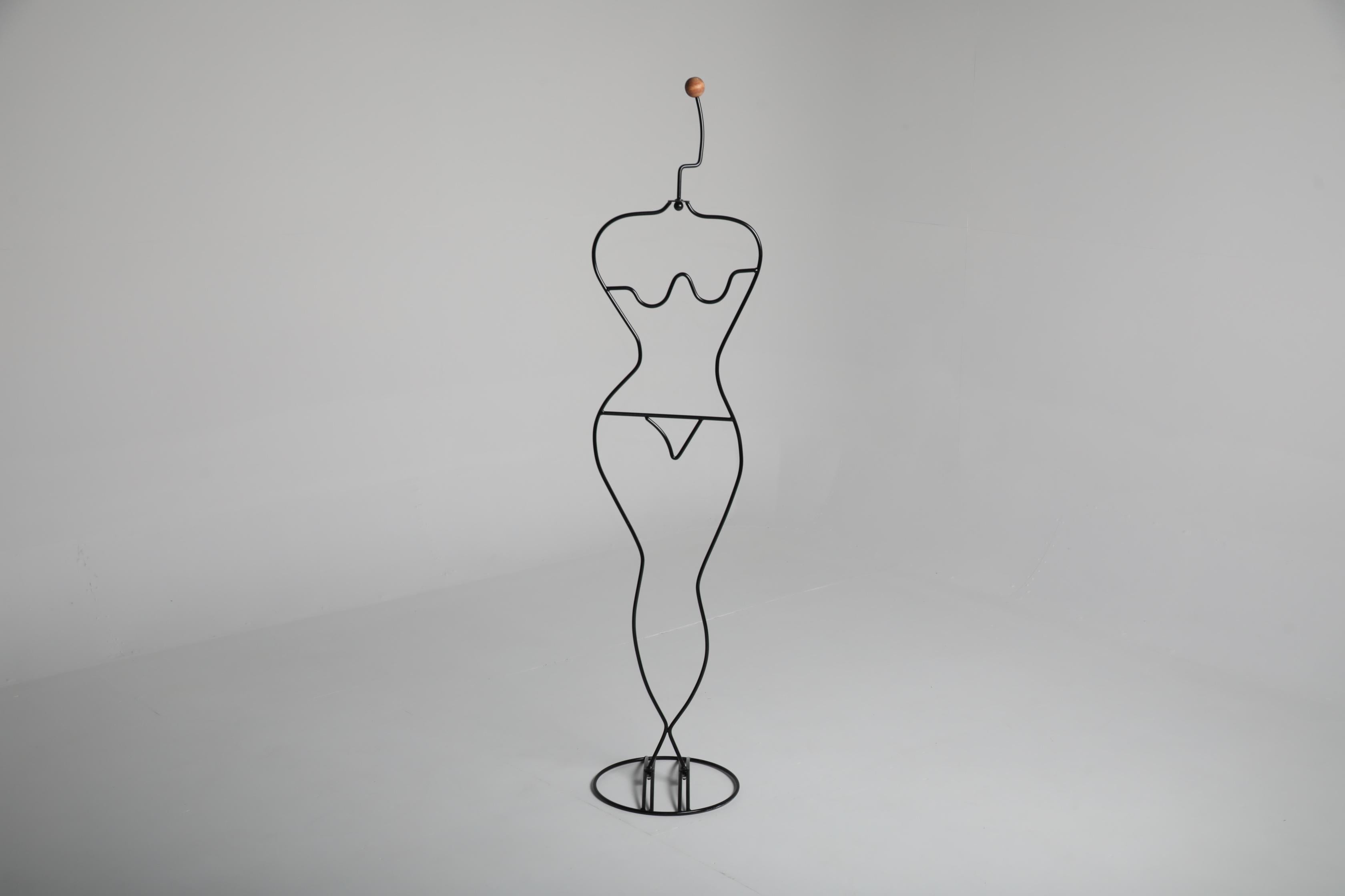 Valet stand designed by Swedish designer Ehlén Johansson for IKEA during the 1980s. Constructed from black lacquered steel wire with a wooden finial, the piece outlines the human form with a sculptural clarity that reflects Scandinavian minimalism