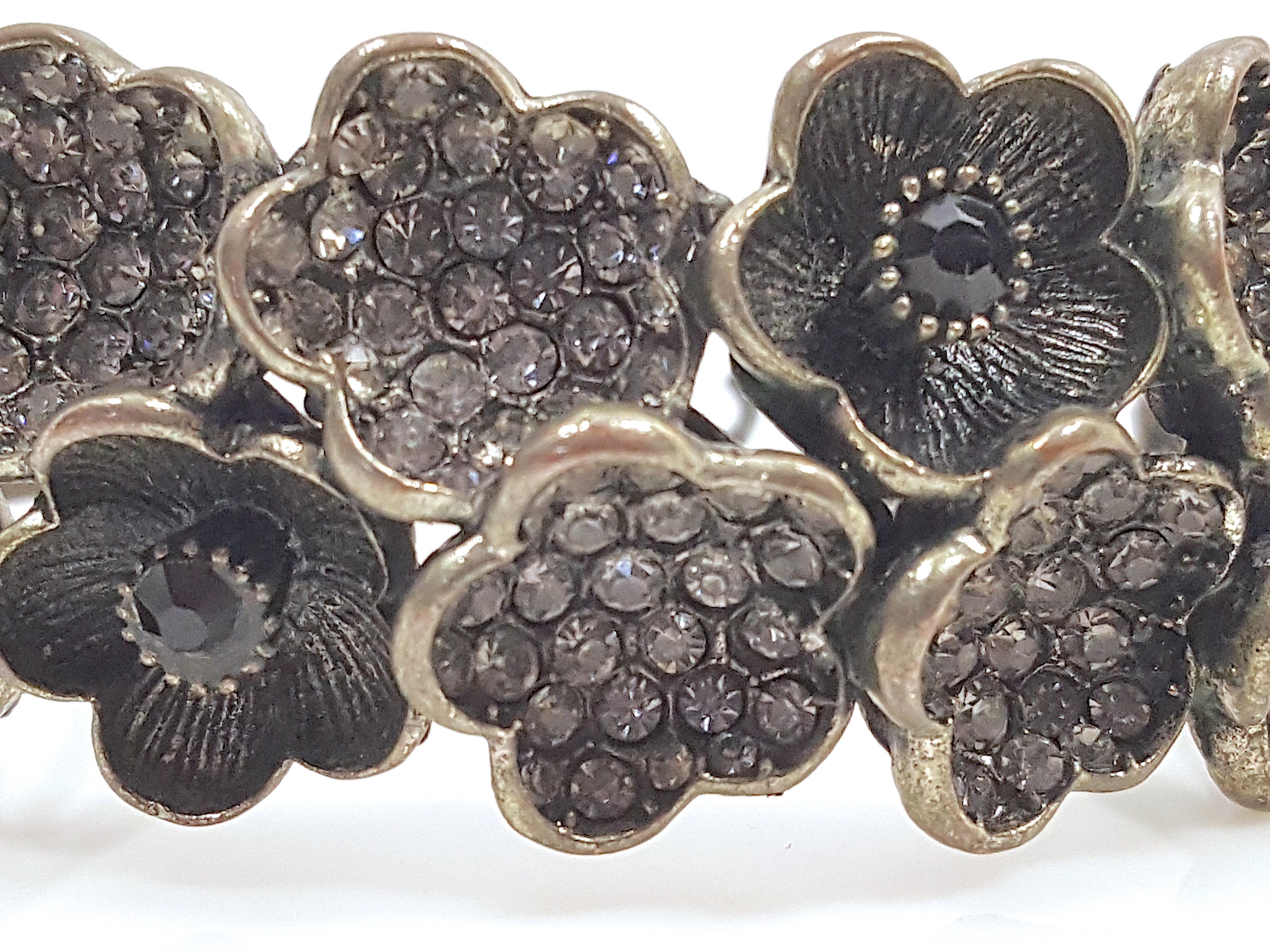 With the mid-century hallmarks of handcrafted costume jewelry by New-York-City-based Hargo Creations but without the post-copyright signature (HAR), this early clamper cuff bracelet featuring stylized concave monochrome textural flowers by the
