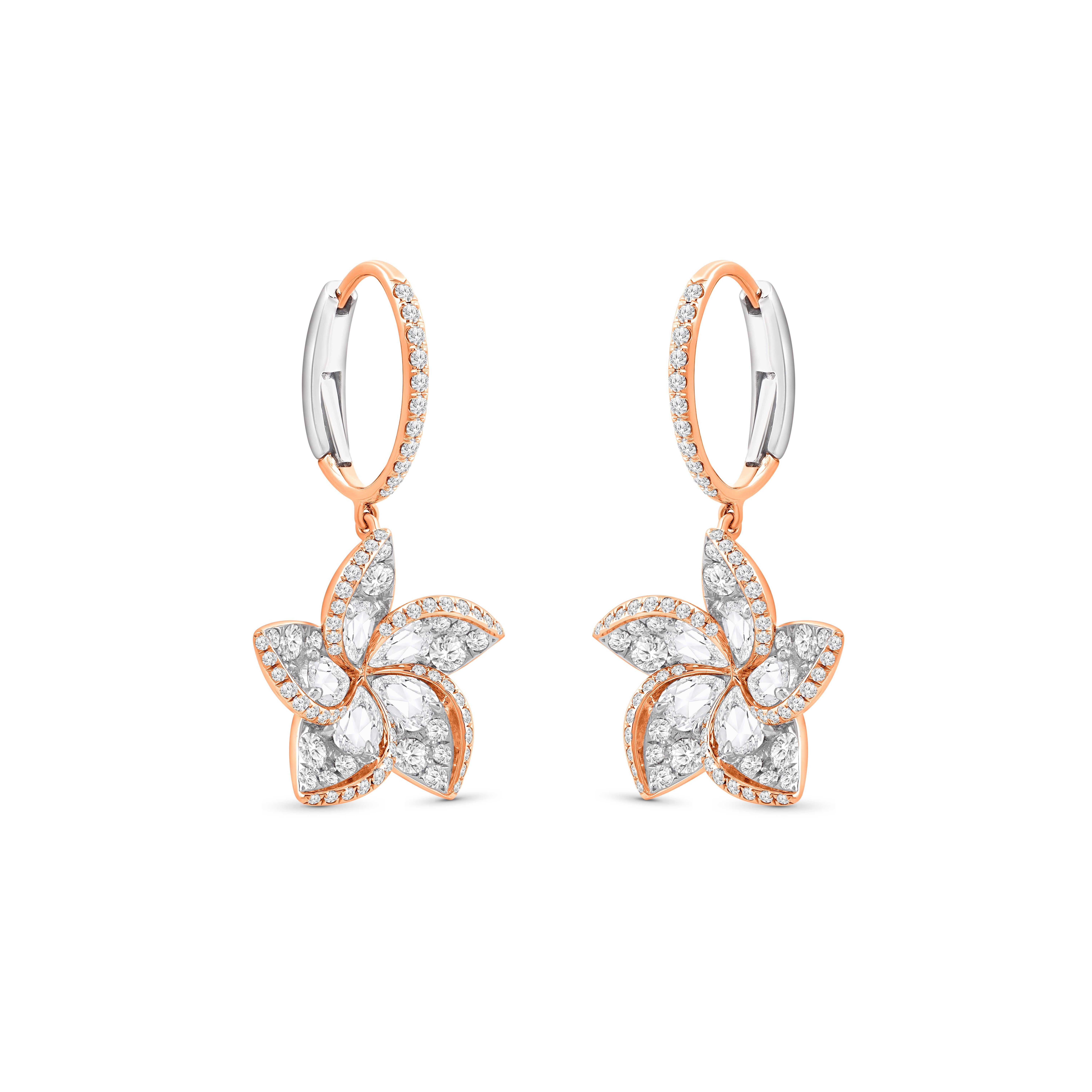A brilliant cluster of diamonds comes together in these beautiful dangle earrings. There are 10 rose-cut pear diamonds and 162 brilliant round-cut diamonds set into these earrings. The diamonds are graded as F color and VS2 clarity. The total