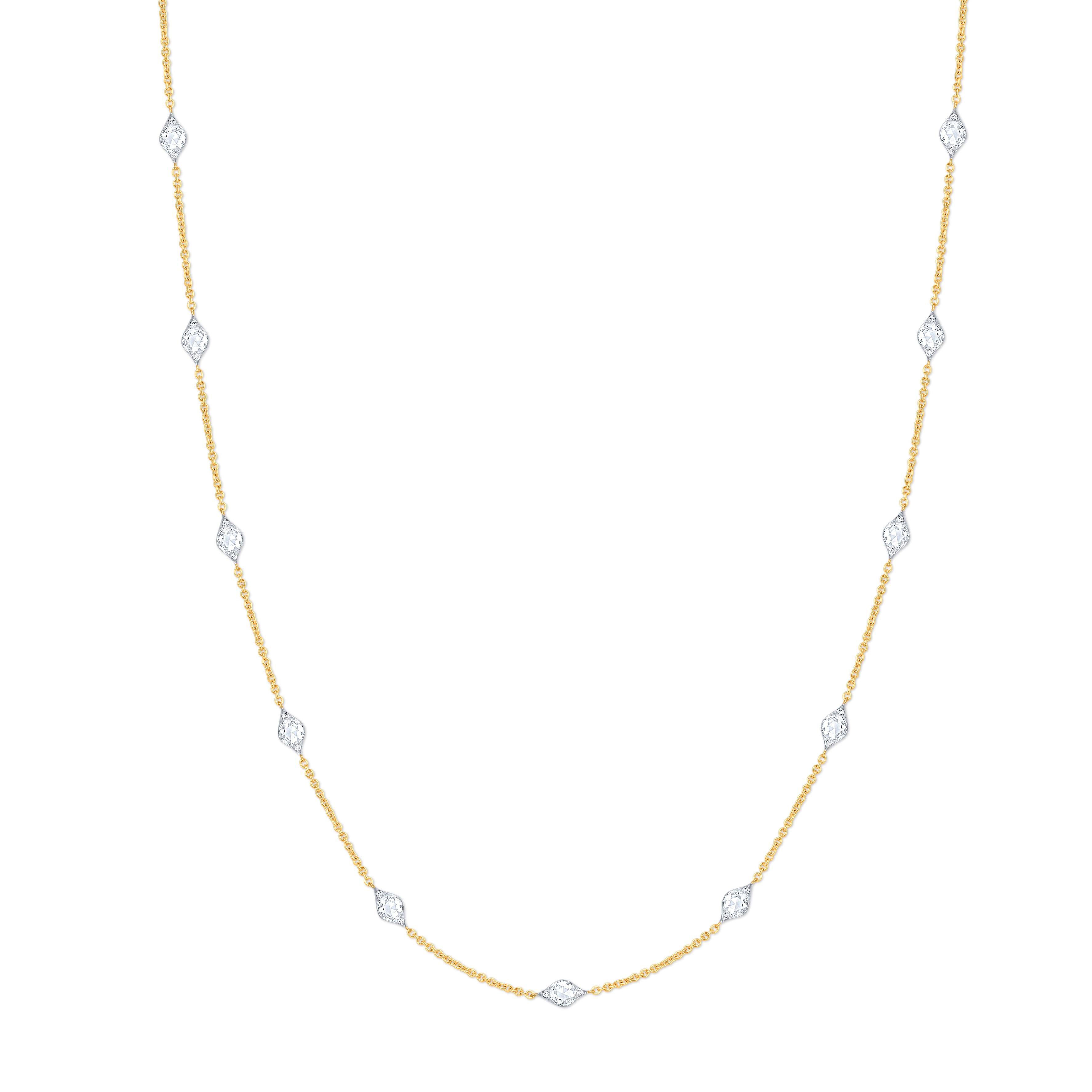 Inspired by the grand Indian havelis of yesteryear, this contemporary station necklace is crafted in 18 KT yellow gold and studded with 68 brilliant cut and 17 rose cut round diamonds. The total diamond weight is 1 1/2 carats. All our diamonds are F