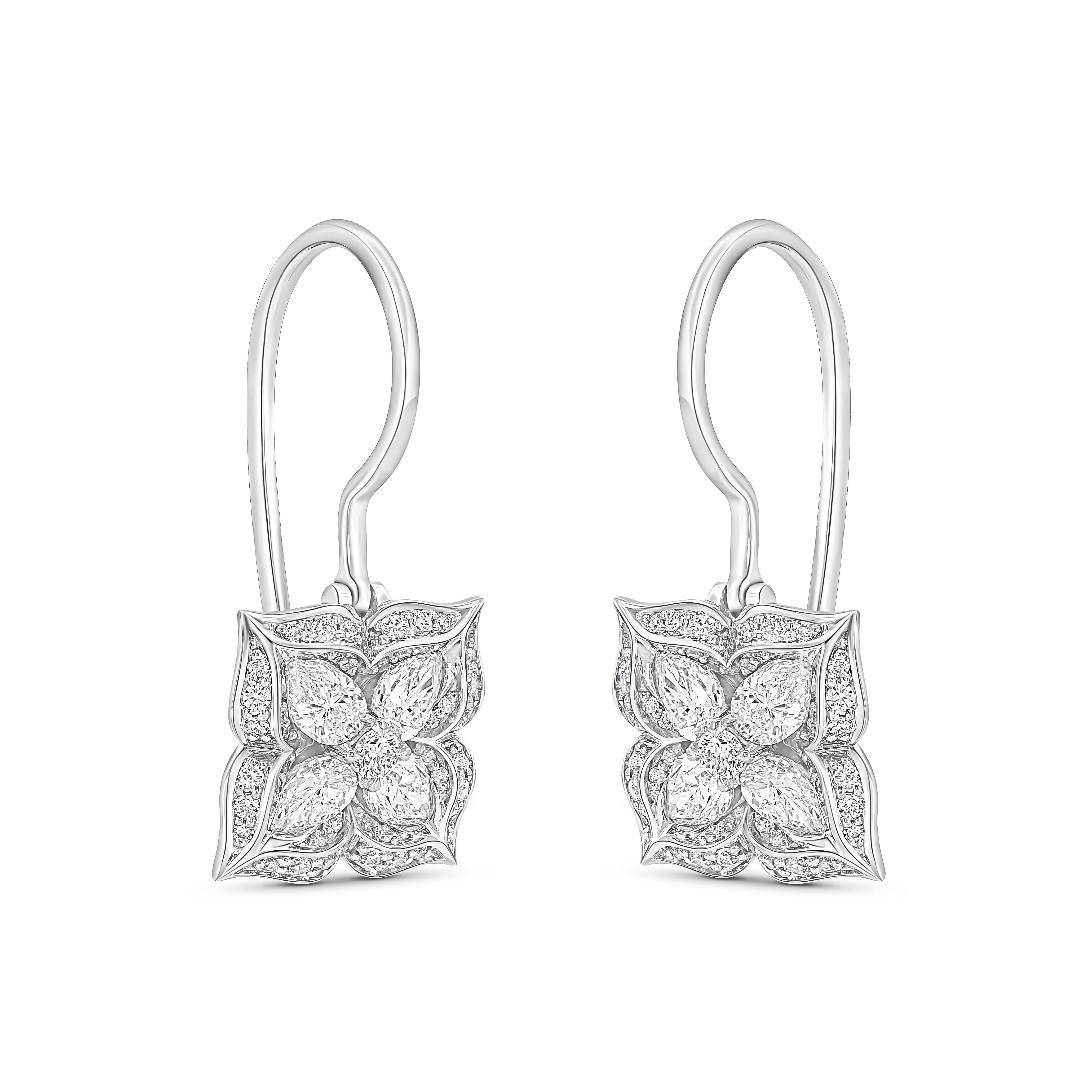 Inspired by the sacred symbols to invoke divinity, these elegantly designed hoop earrings are studded with 8 pear-cut, 82 brilliant-cut round diamonds, for a total of 1 1/3 carats of natural colorless diamonds in a prong setting, beautifully crafted