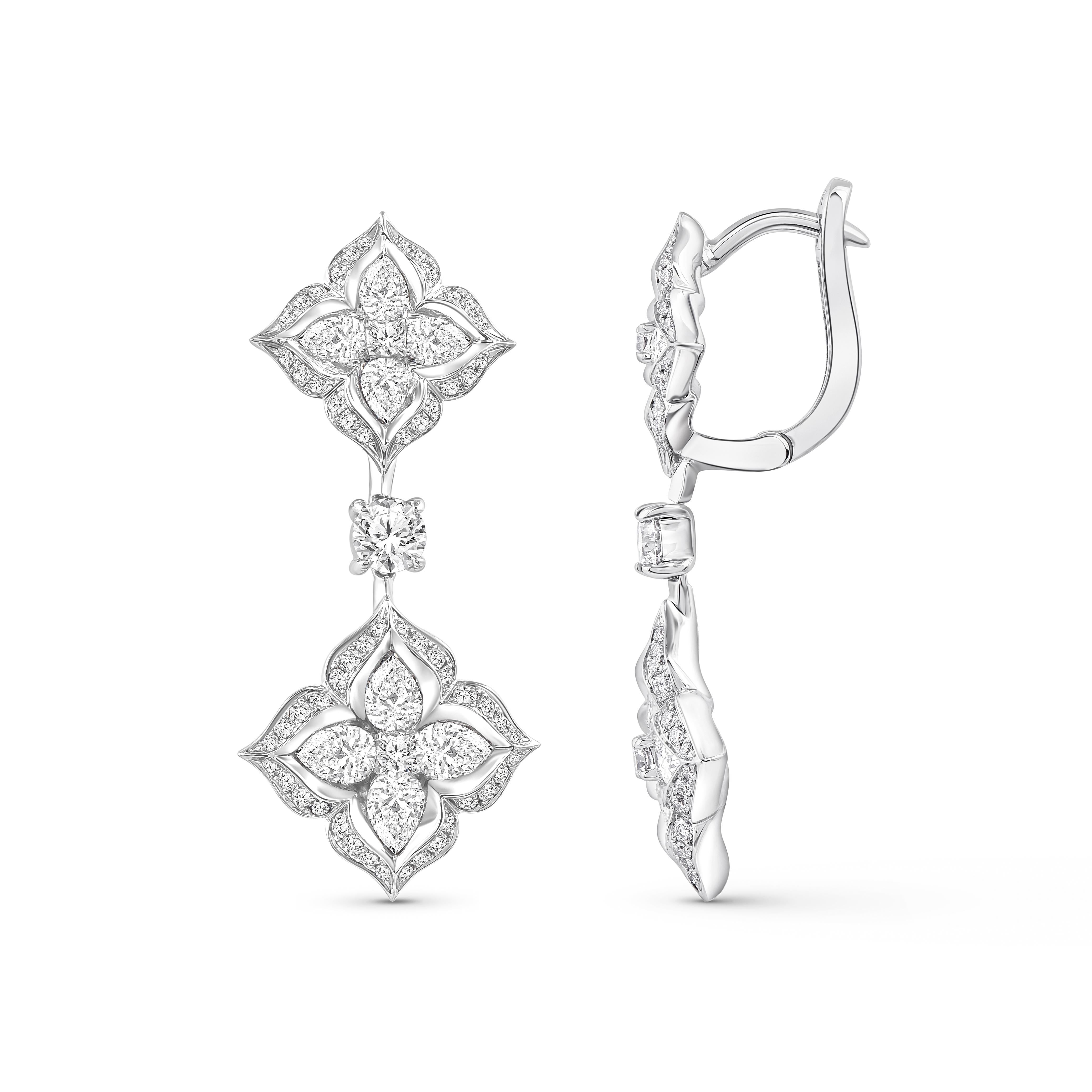 Inspired by the grand Indian havelis (royal abode) of yesteryear, these contemporary hoop earrings are crafted in 18 KT white gold and are studded with 118 brilliant-cut round, 16 pear-cut natural colorless diamonds. The total diamond weight is 1