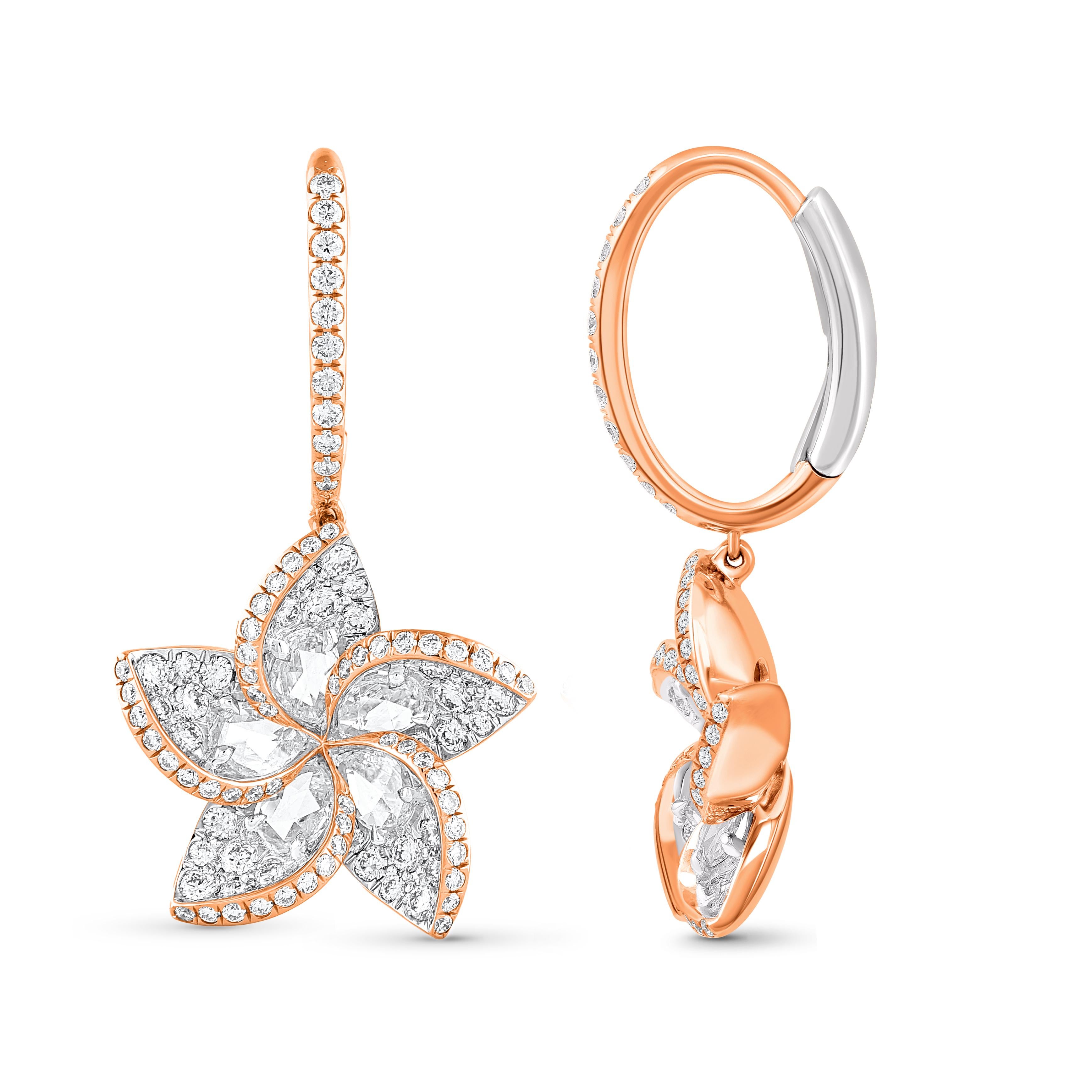 A brilliant cluster of diamonds comes together in these beautiful dangle earrings. The diamonds are graded as F color and VS2 clarity. The total diamond weight of the earrings is 1 5/8 CT and these earrings are meticulously crafted in 18 KT rose