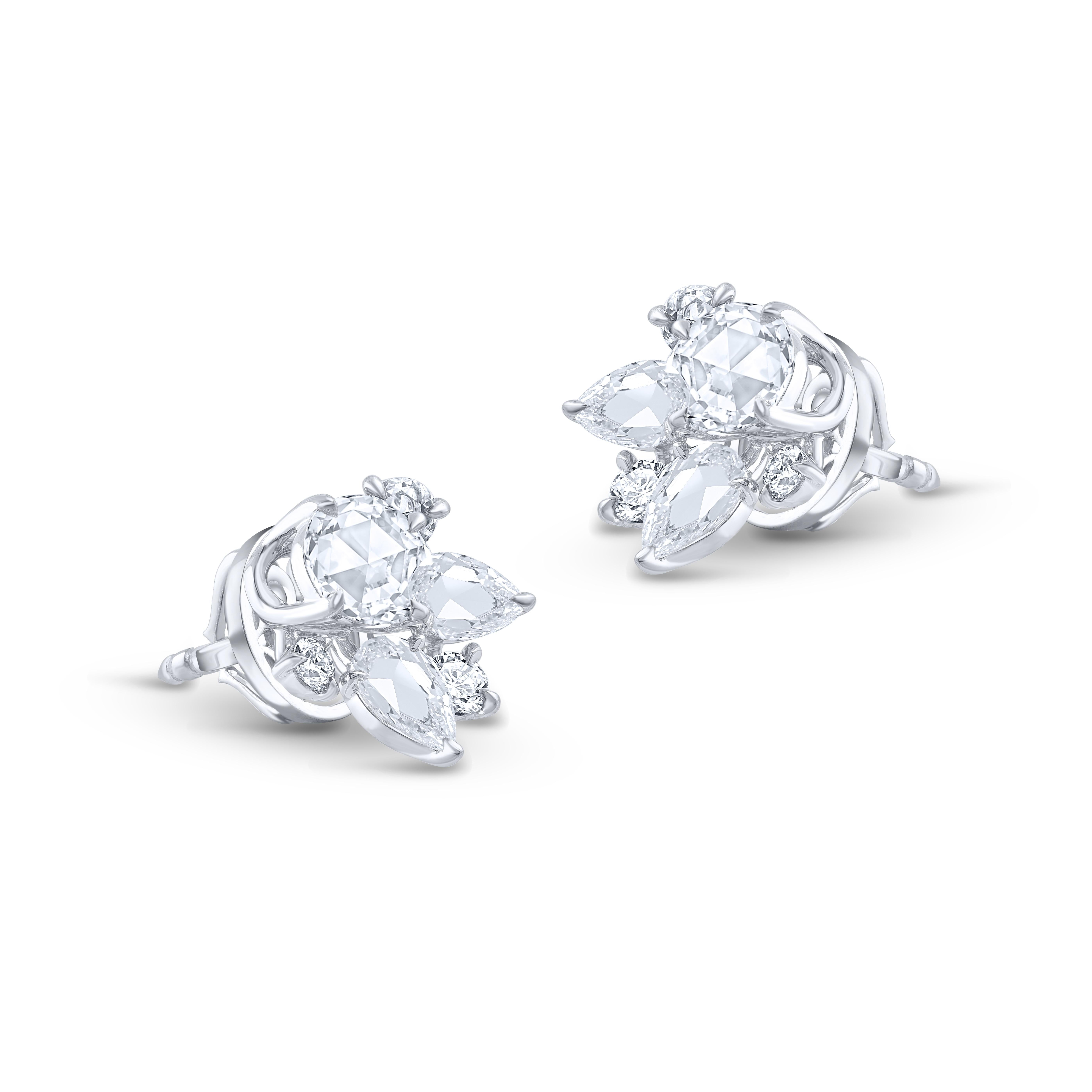 A brilliant cluster of colorless diamonds crafted meticulously to make these stud earrings. Studded with 4 round, 4 baguette, 2 pear, 4 rose cut round, 2 rose cut marquise diamonds. All the diamonds are D-F color, IF-VS clarity, the total diamond