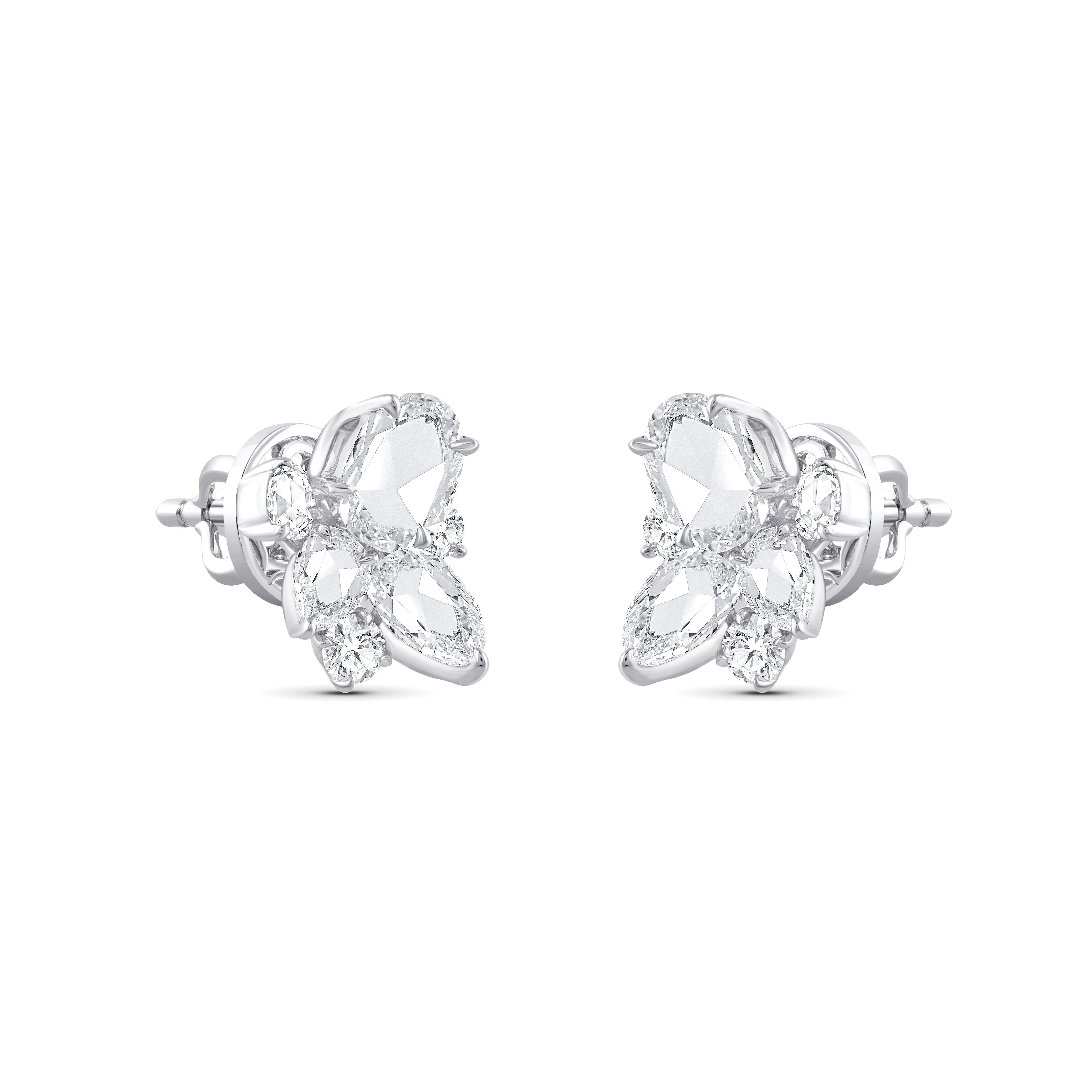 A brilliant cluster of colorless diamonds crafted meticulously to make these stud earrings. Studded with 4 round, 4 baguette, 2 pear, 4 rose cut round, and 2 rose cut marquise diamonds. All the diamonds are F color, VS2 clarity; the total diamond