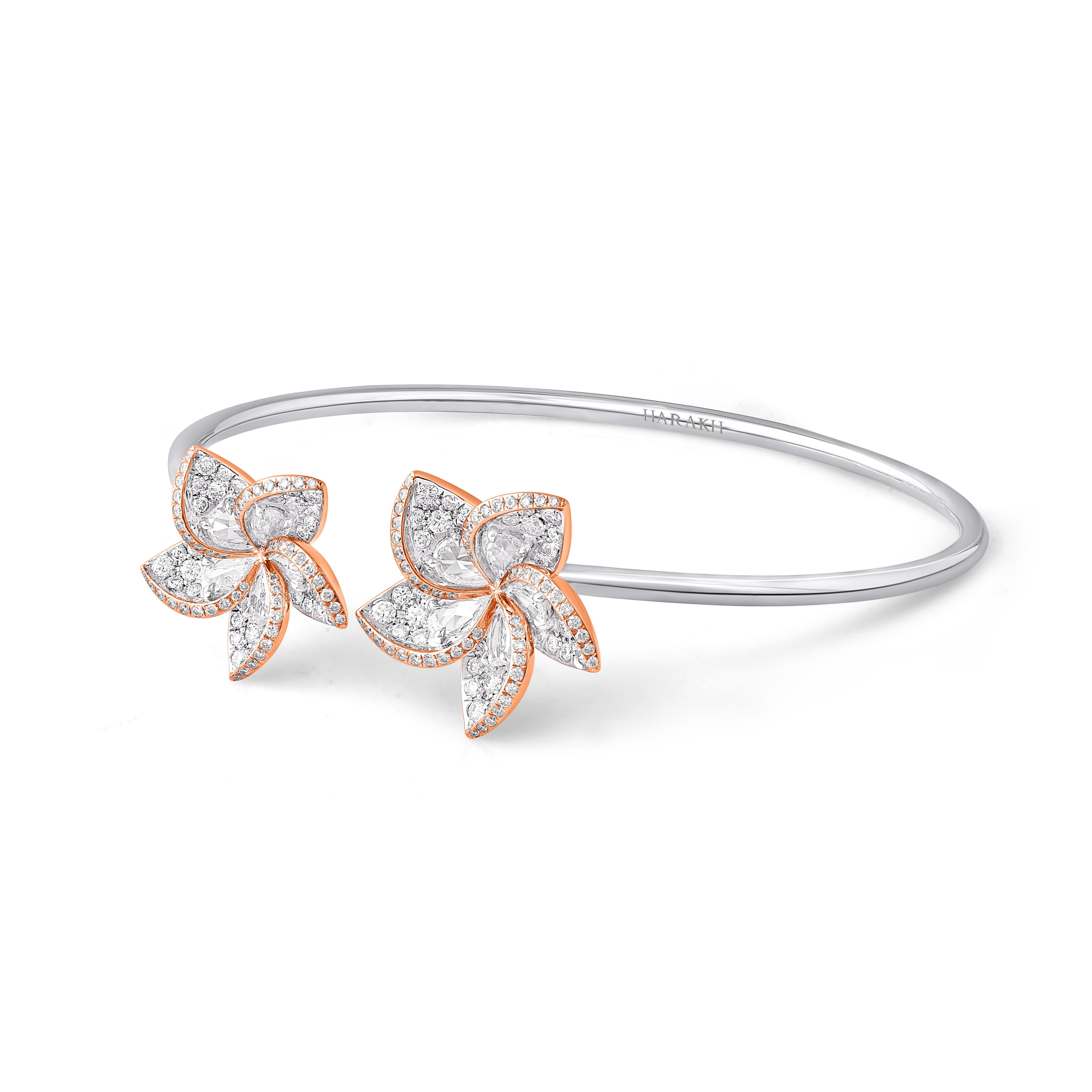 A beautifully designed bangle bracelet studded with 175 round diamonds, 10 rose cut pear diamonds. This designer bracelet is from our Frangipani collection. Diamonds are graded as F color and VS2 Clarity.

This 1 3/4 carat bracelet will be