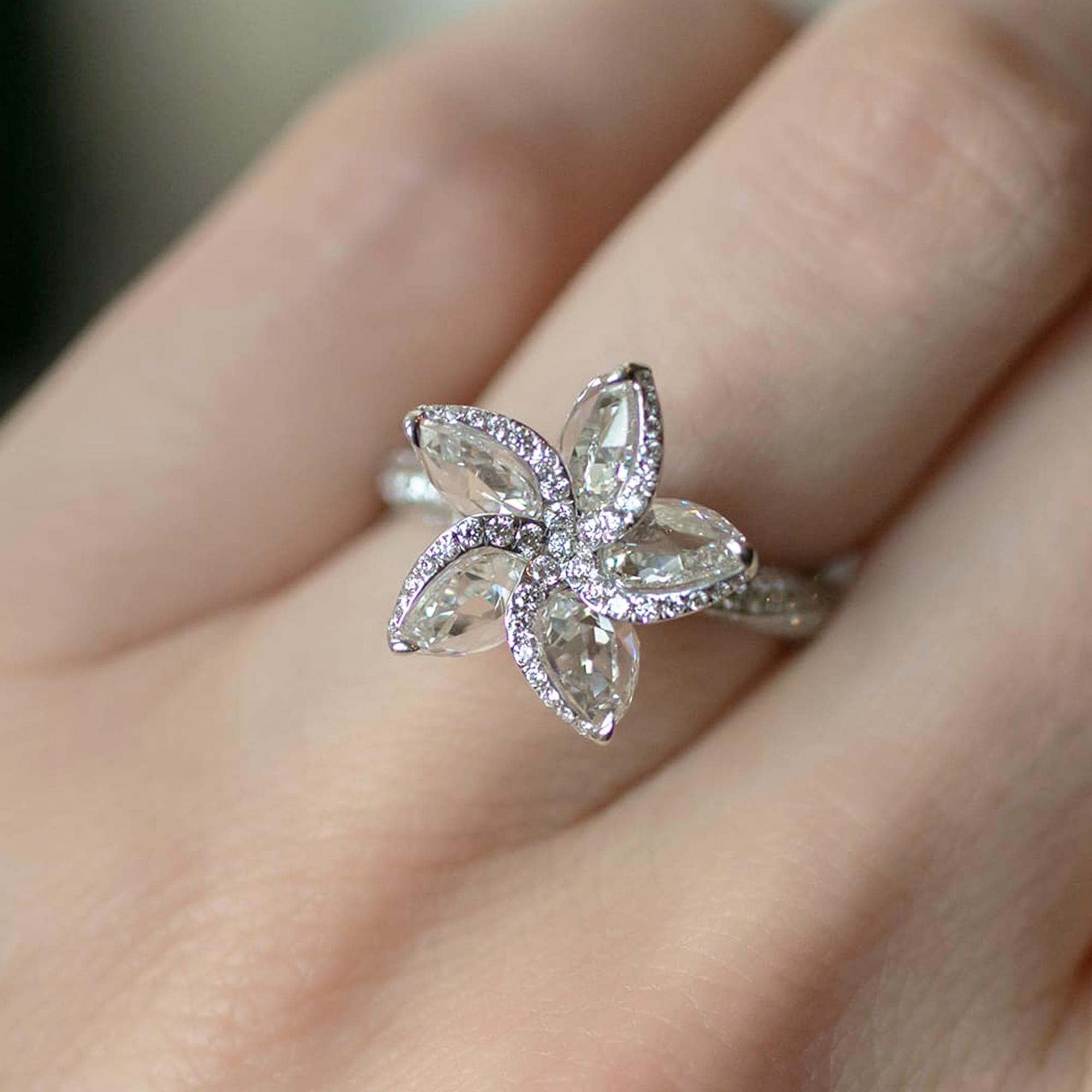 This beautiful floral ring features shimmering pear rose cut diamonds and brilliant round in pave setting resembling petals, with a diamond studded shank crafted in 18 karat white gold.

The ring is studded with 141 round and 5 rose cut pear