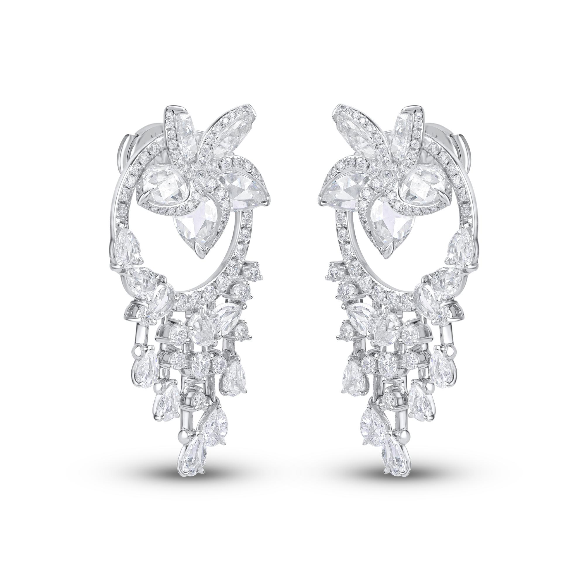 Handcrafted in 18 kt white gold, these versatile diamond earrings are studded with 140 brilliant cut round diamonds and 30 rose cut pear shaped diamonds. The top portion of the Frangipani Flower is detachable and can be worn on its own to form a