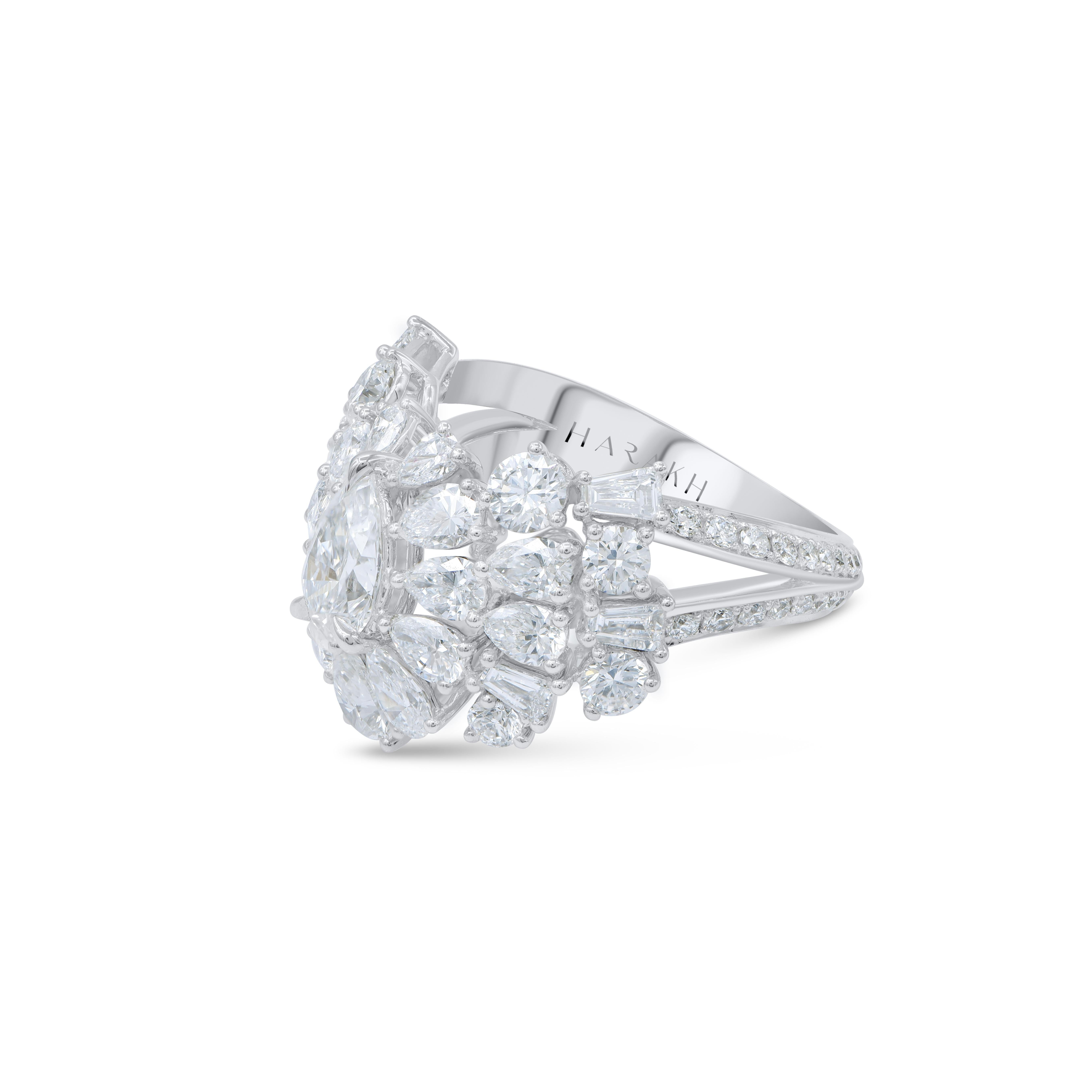 This bridal diamond ring has a GIA certified 0.73 carat pear shaped center stone surrounded beautifully with 56 brilliant round diamonds, 6 baguettes, 16 pear shape diamonds including center stone. Handcrafted in 18 kt white gold, the total diamond