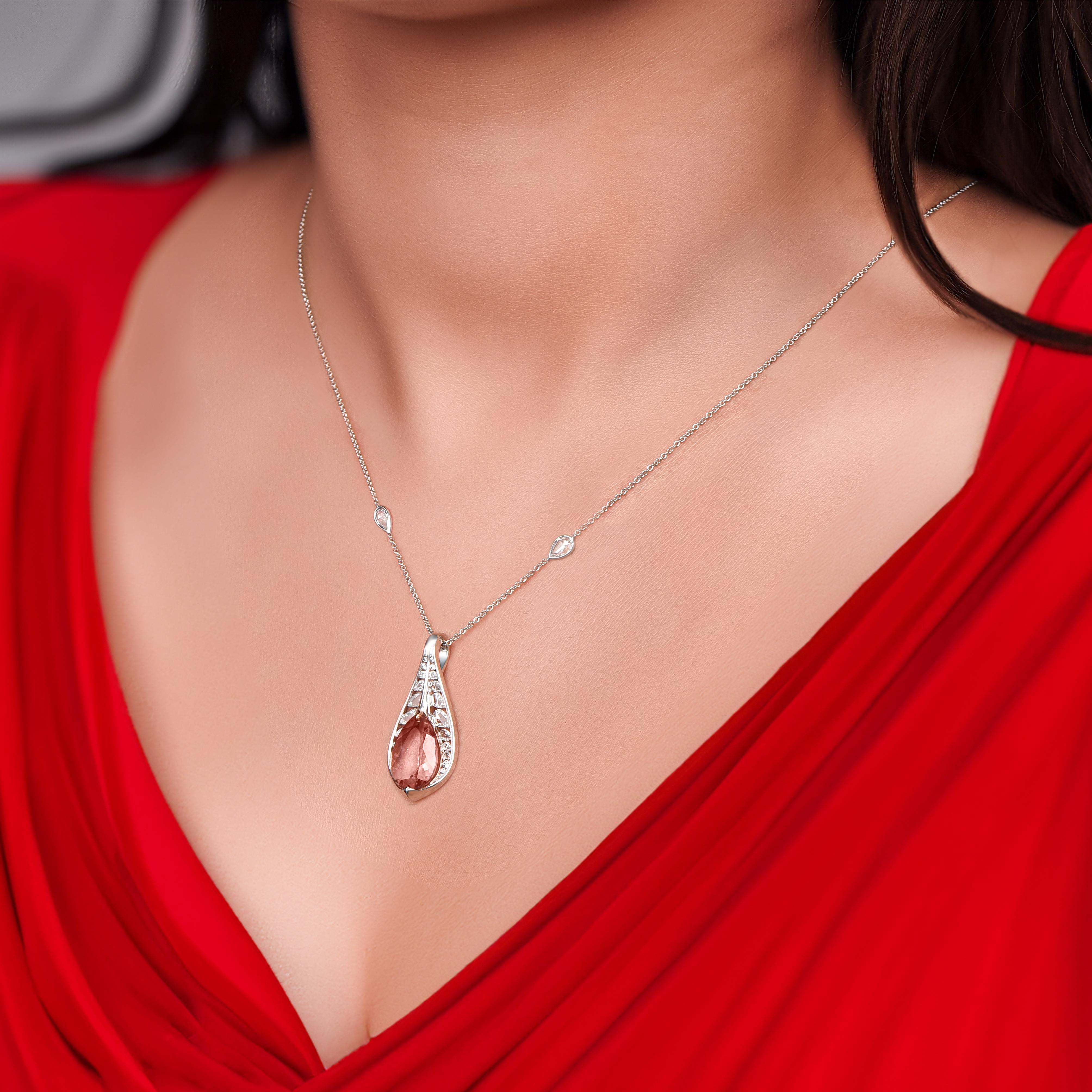 Inspired by the Fragrant Frangipani flower, a symbol of immortality, this elegantly designed pendant is adorned with a harmonious 10-round brilliant cut, 16 rosecut-pear natural diamonds, and 1 pink tourmamine. A nature-inspired beauty from our