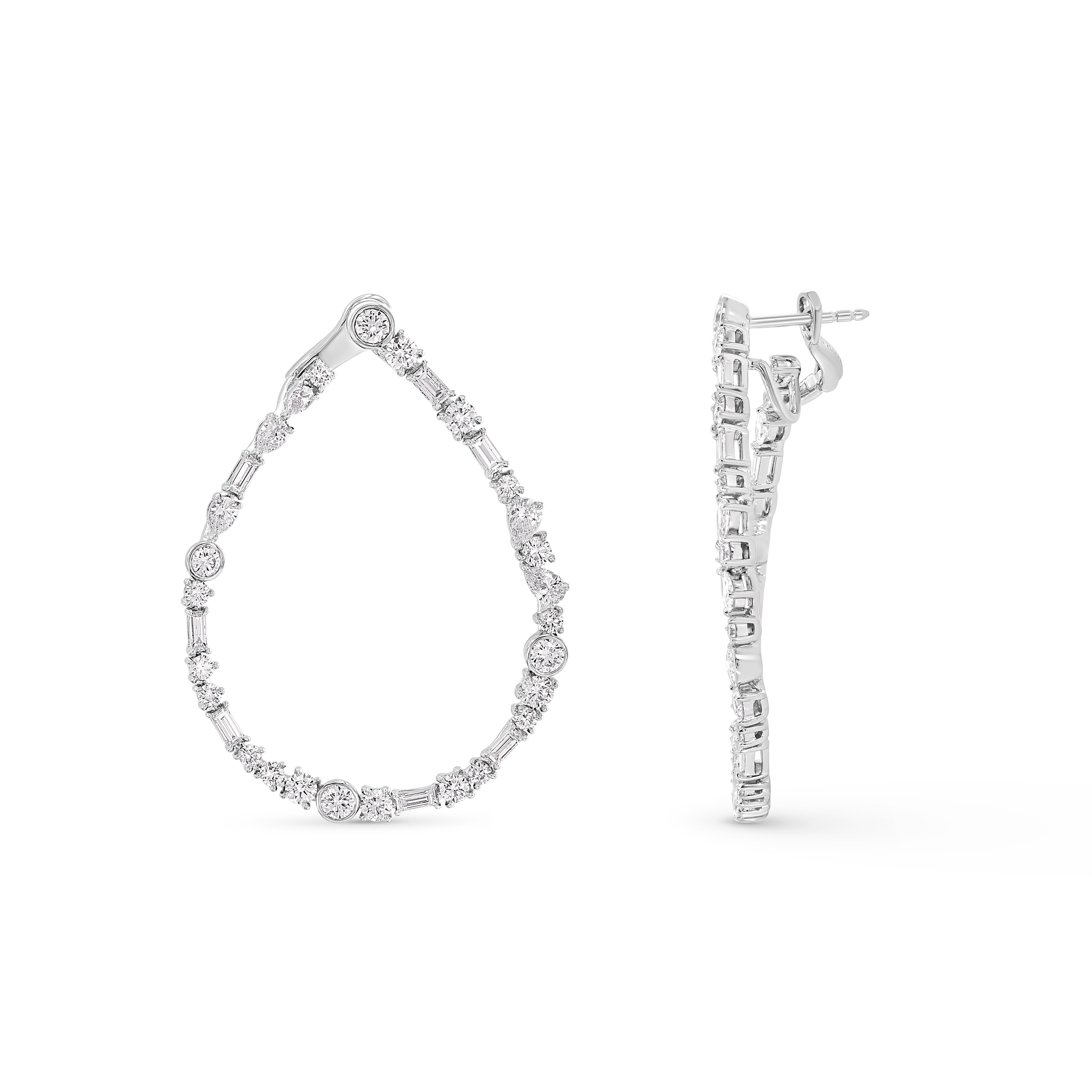 Inspired by the magic of dancing in a long-awaited monsoon, these statement diamond hoop earrings from our Raindrop collection feature 14 baguette diamonds, 10 pear-cut diamonds, and 42 brilliant-cut natural diamonds and are crafted in 18kt white