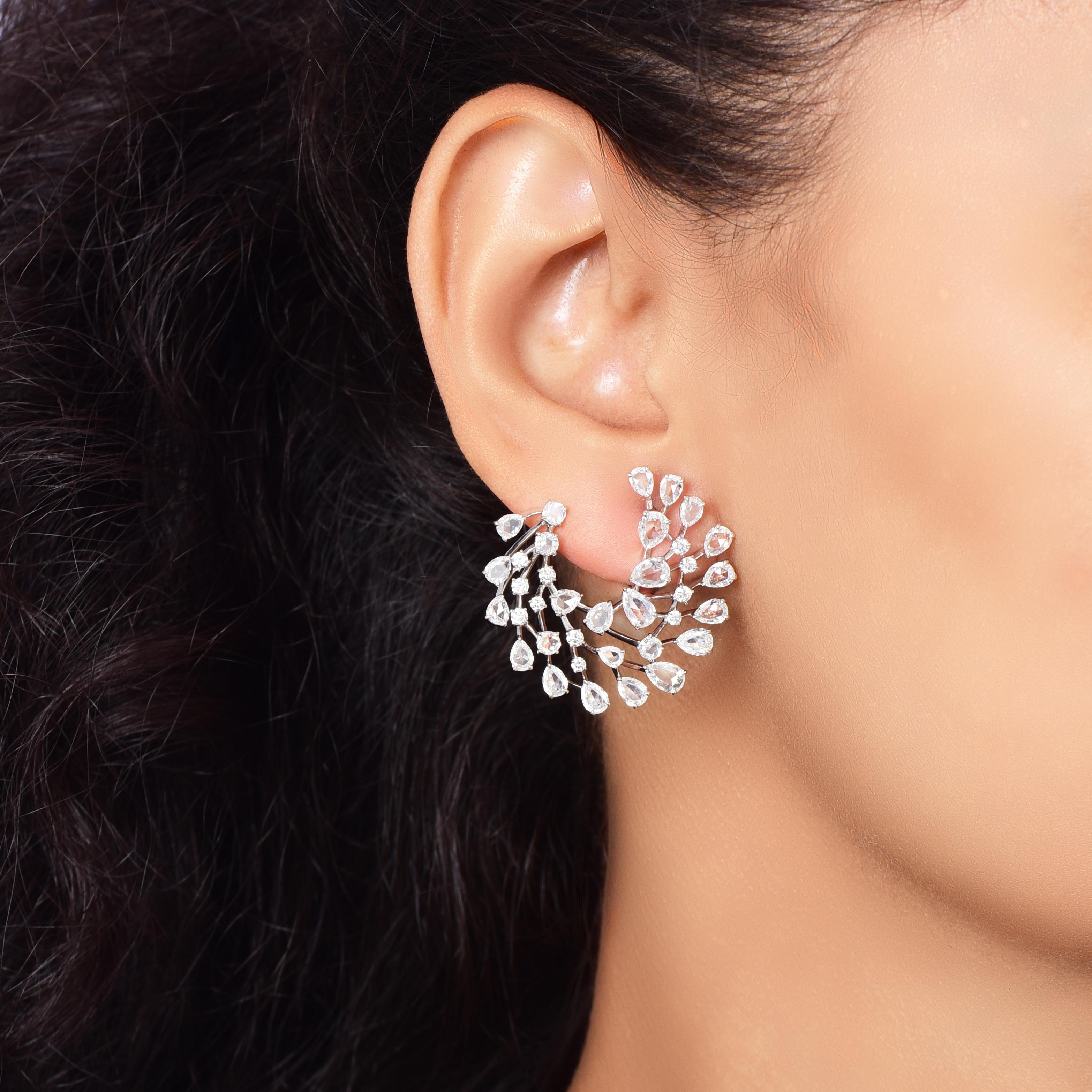 A brilliant cluster of diamonds beautifully designed to form these hoop earrings. Studded with 22 brilliant cut, 8 rose cut round and 42 rose cut pear diamonds, D-F color, IF-VS clarity. The total diamond weight of the earrings is 5. 00 carats and