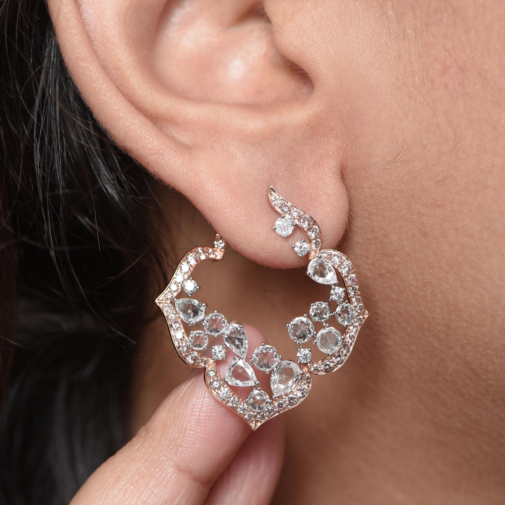 Inspired by the grand Indian havelis (royal abode) of yesteryear, these contemporary inside out earrings are crafted in 18 KT rose and are studded with 140 diamonds including natural pink diamonds, brilliant and rose cut diamonds. 

A spread of rose