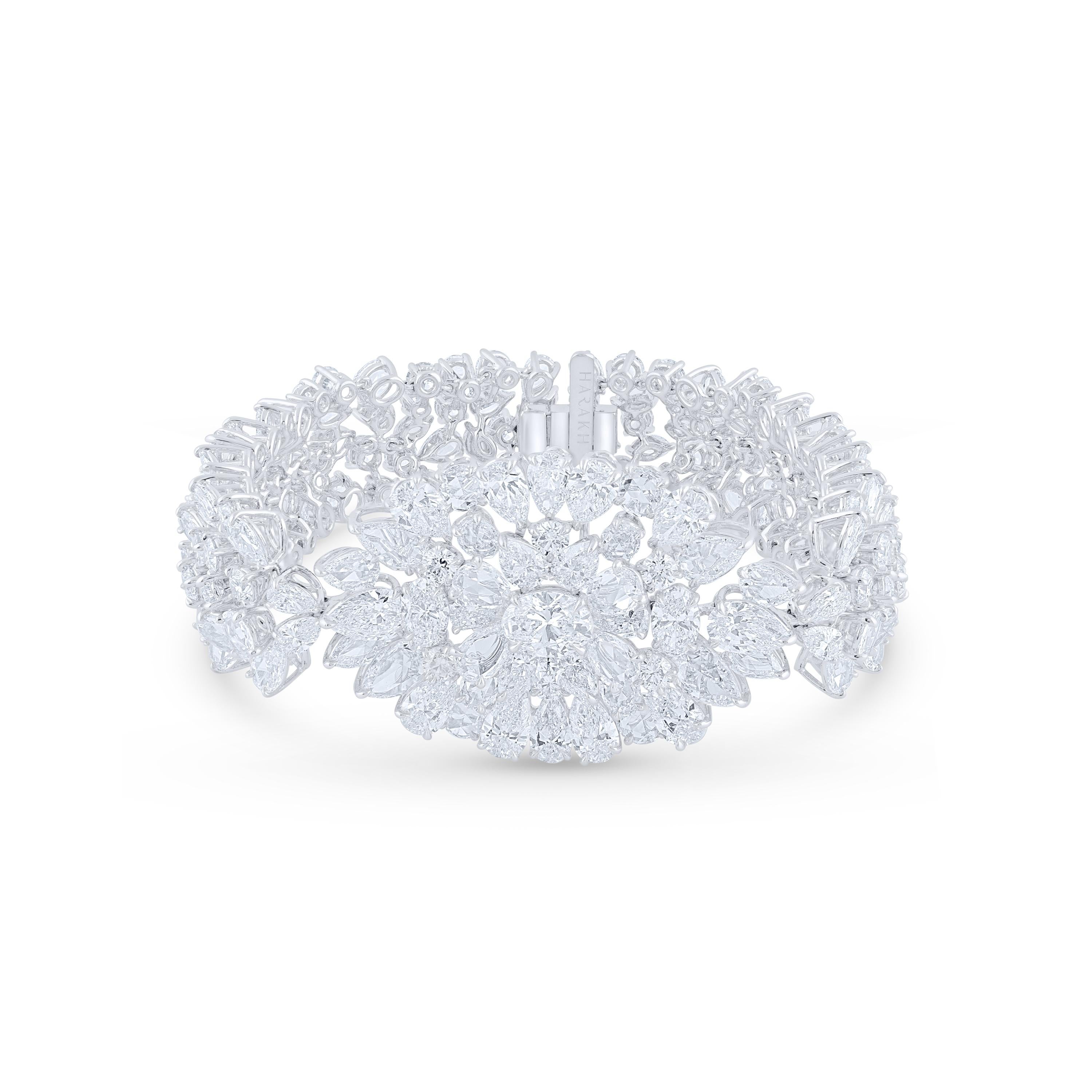 This 32-carat bracelet had two straps of diamonds holding a central oval cluster set with brilliant-cut round, oval- and pear-shaped stones, interspersed with rose-cut gems in various shapes. Crafted in 18 KT White Gold (Paladium alloyed).  Studded