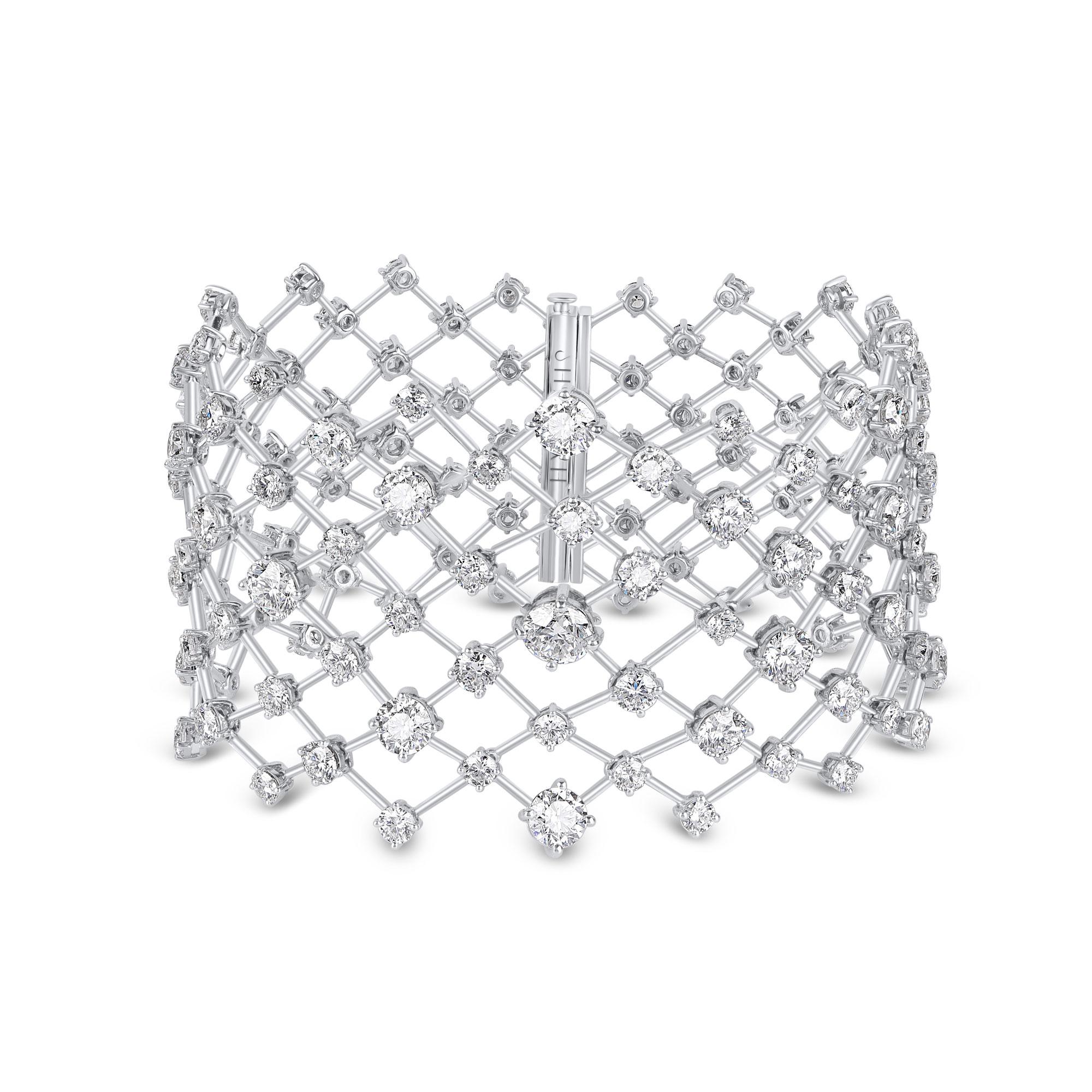 The bracelet is set with 199 brilliant cut round diamonds in claw setting, in a unique design, reminiscent of stars Illuminating the night skies. The total diamond weight of this bracelet is 22.15 carats. Using a proprietary linking mechanism, this