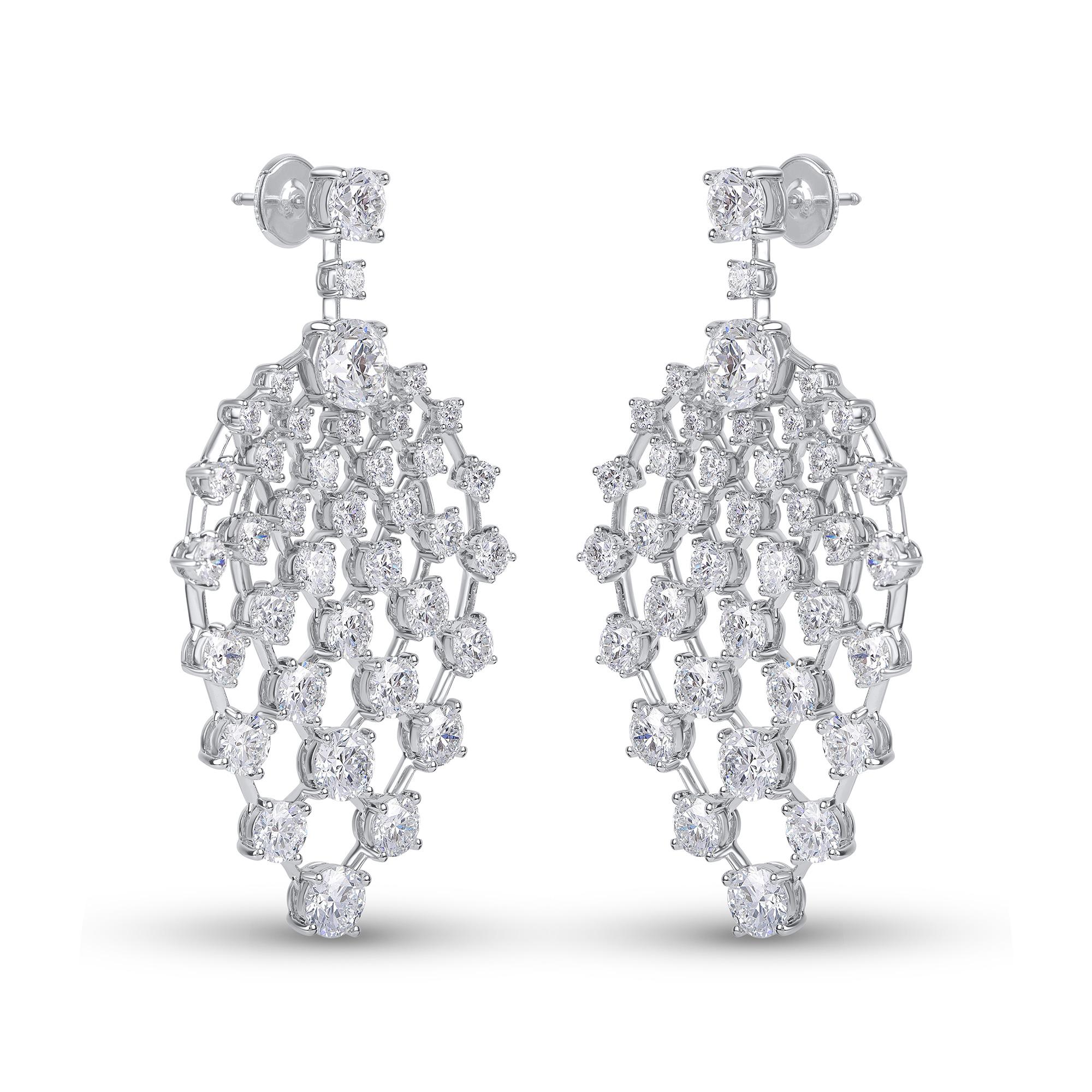 This pair of dangling earrings is beautifully set with an star-like arrangement of 76 brilliant cut diamonds in claw setting, in a unique design, reminiscent of stars Illuminating the night skies. The total diamond weight of these earrings is 12.80
