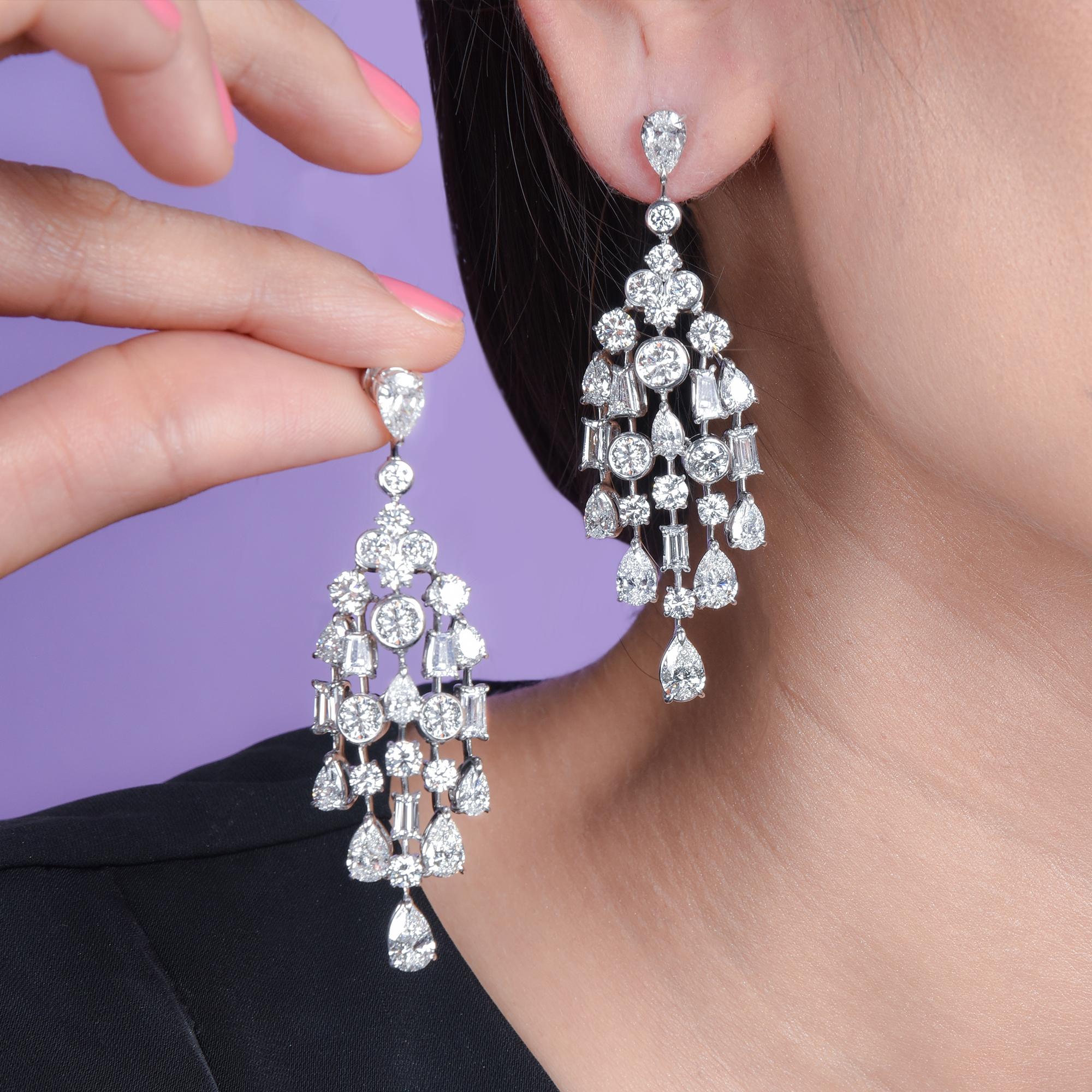 These high jewelry earrings from our Raindrop Collection are studded with 28 brilliant round cut diamonds, 10 tapered baguettes, 18 pear shape diamonds, in bezel and claw setting and crafted in platinum. It secures comfortably with guardian post