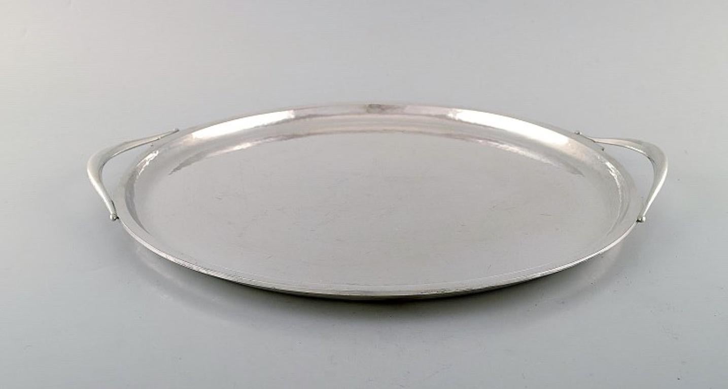 Harald Nielsen for Georg Jensen. 
Large Art Deco serving tray in hammered sterling silver. 
Model Number 847.
Measures: 38 x 3 cm.
Stamped.
In very good condition.