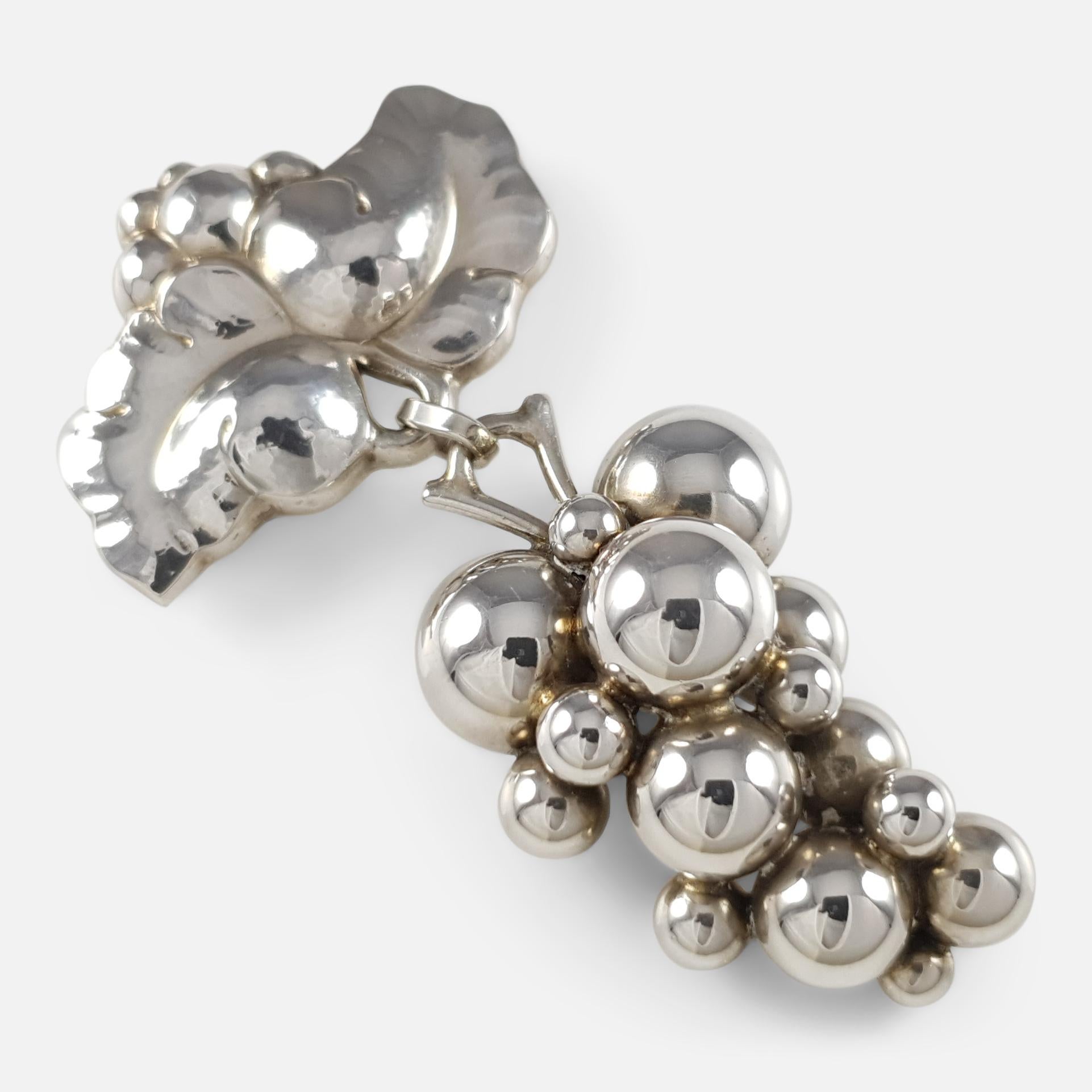 Item: - A superb Georg Jensen sterling silver moonlight grapes brooch, design #217 B. The brooch is designed by Harald Nielsen for Georg Jensen. Stamped Georg Jensen within dotted oval mark, '925S', and 'Denmark'.  The brooch is UK hallmarked,