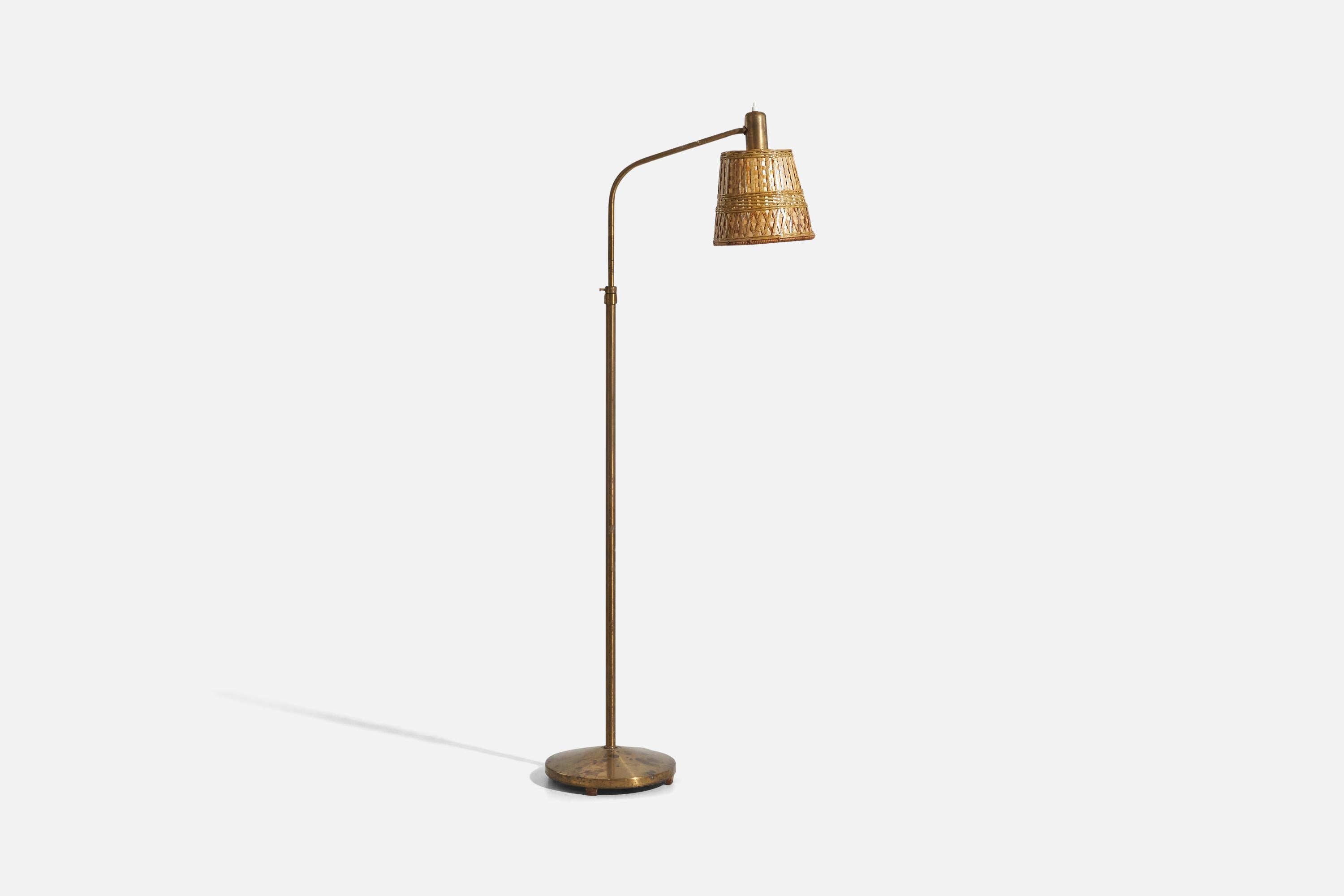 A brass and rattan, adjustable floor lamp designed by Hans Bergström and produced by ASEA, Sweden, 1940s.

Dimensions variable, measured as illustrated in first image.

Sold with Lampshade(s). Dimensions stated are of floor lamp with shade(s).