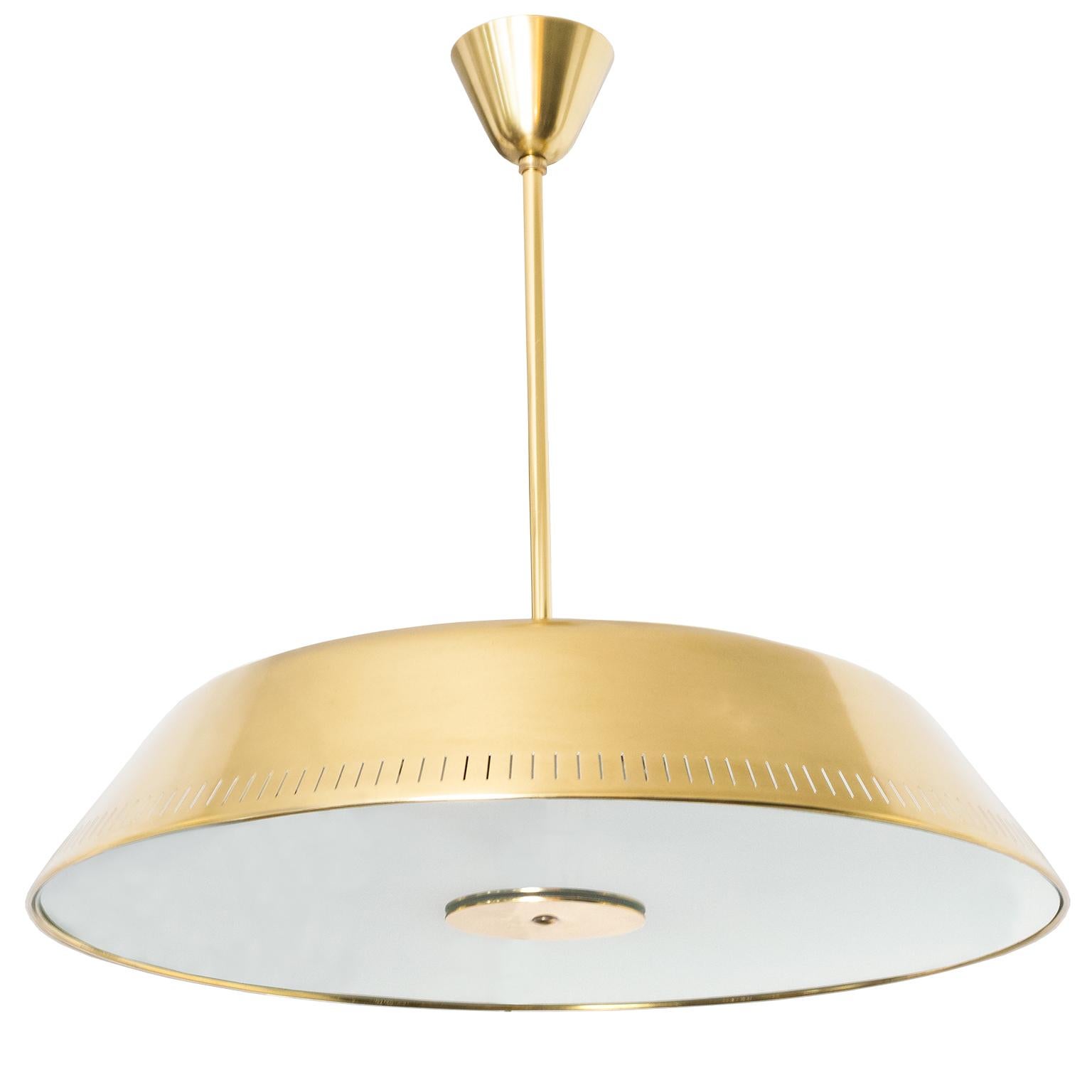 Sleek Scandinavian Modern polished brass and glass pendant designed by Harald Notini made by Böhlmarks, Sweden. This fixture has been completely restored and newly rewired with 6 internal standard base sockets and 3 additional sockets recessed on