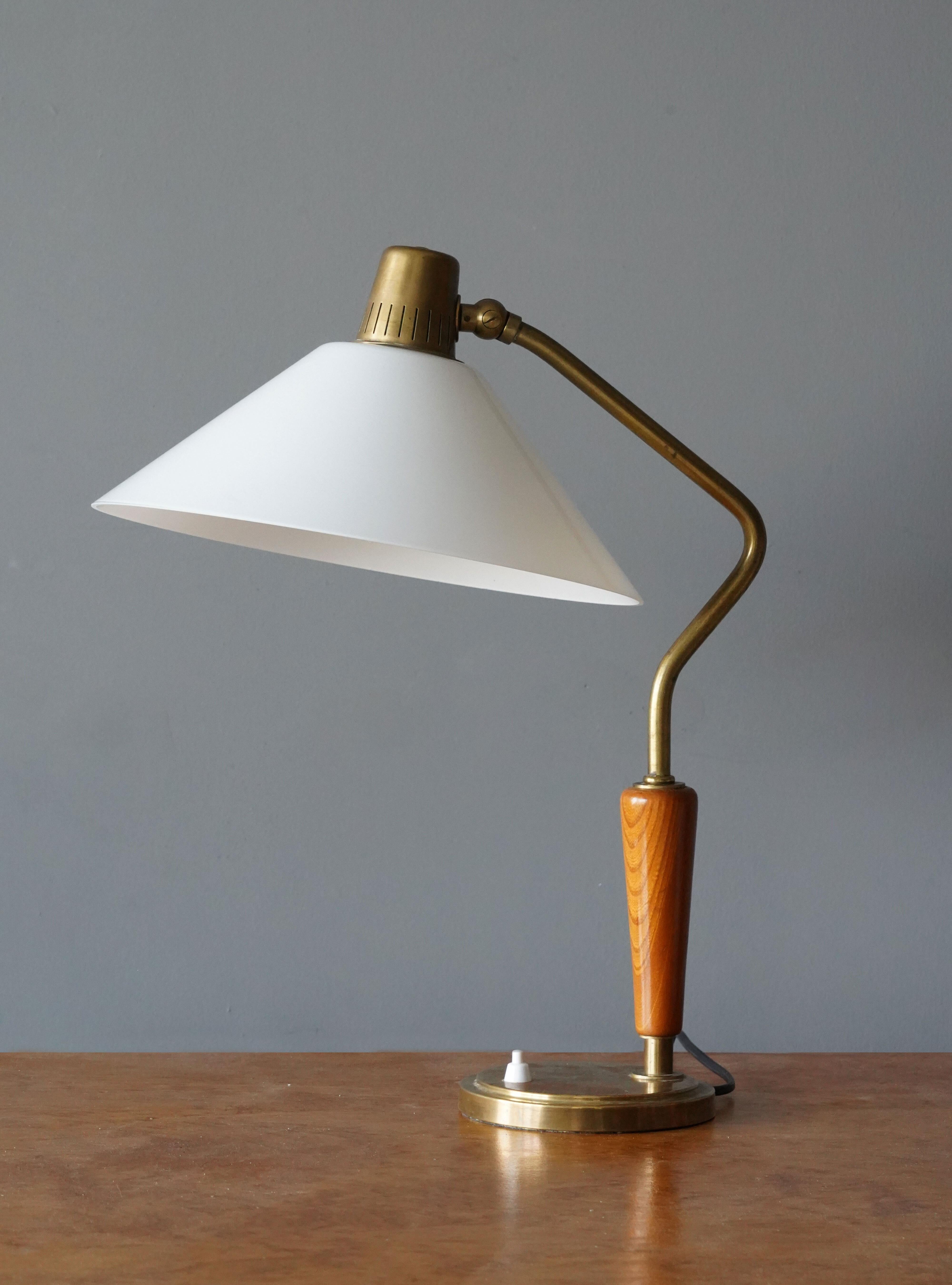 An adjustable table lamp. Designed by Harald Notini. Manufactured by Böhlmarks Lampfabrik, Sweden, 1940s. Brass and elm and milk glass. Documented and stamped with makers mark and model number to underside.

Other designers of the period include