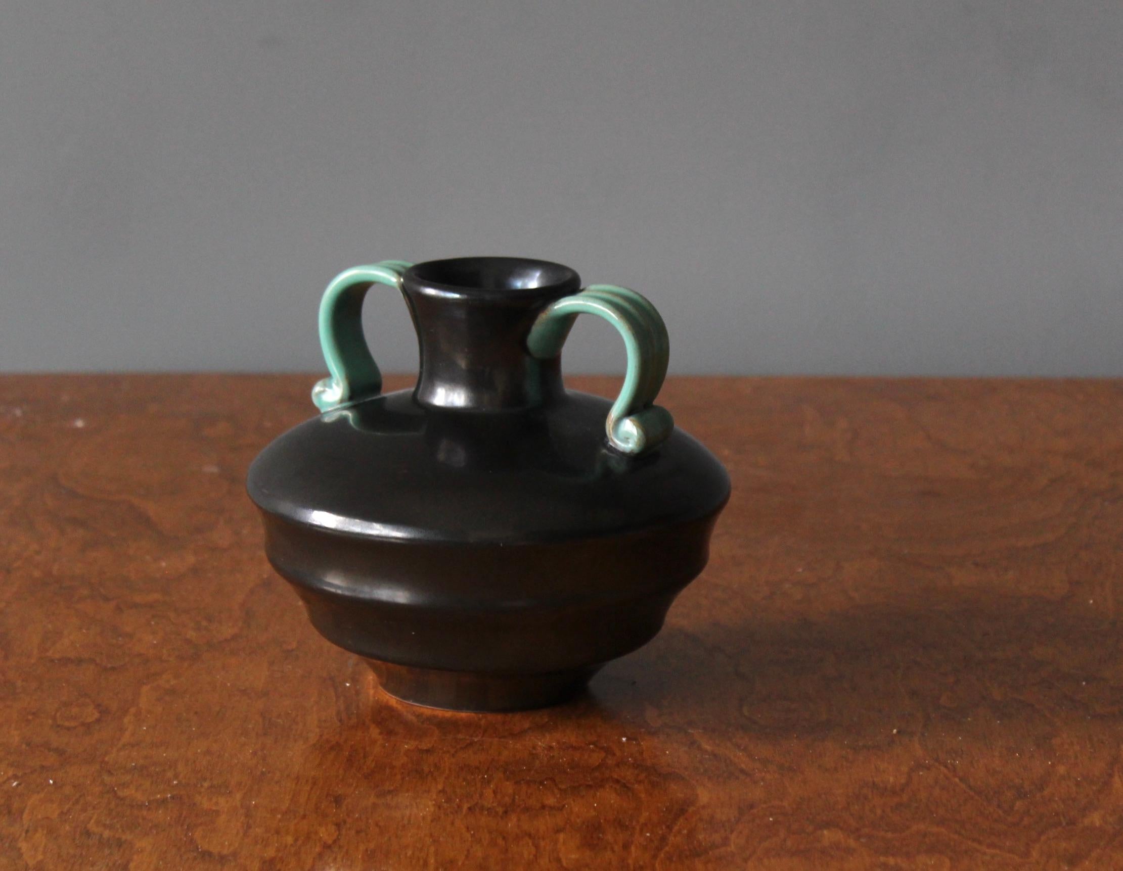 An early modernist vase. Produced by Upsala-Ekeby, Sweden, 1940s. Designed by Harald Östergren (1888-1974). Features black / green glaze. Earthenware.

Other designers of the period include Ettore Sottsass, Carl Harry Stålhane, Lisa Larsson, Axel