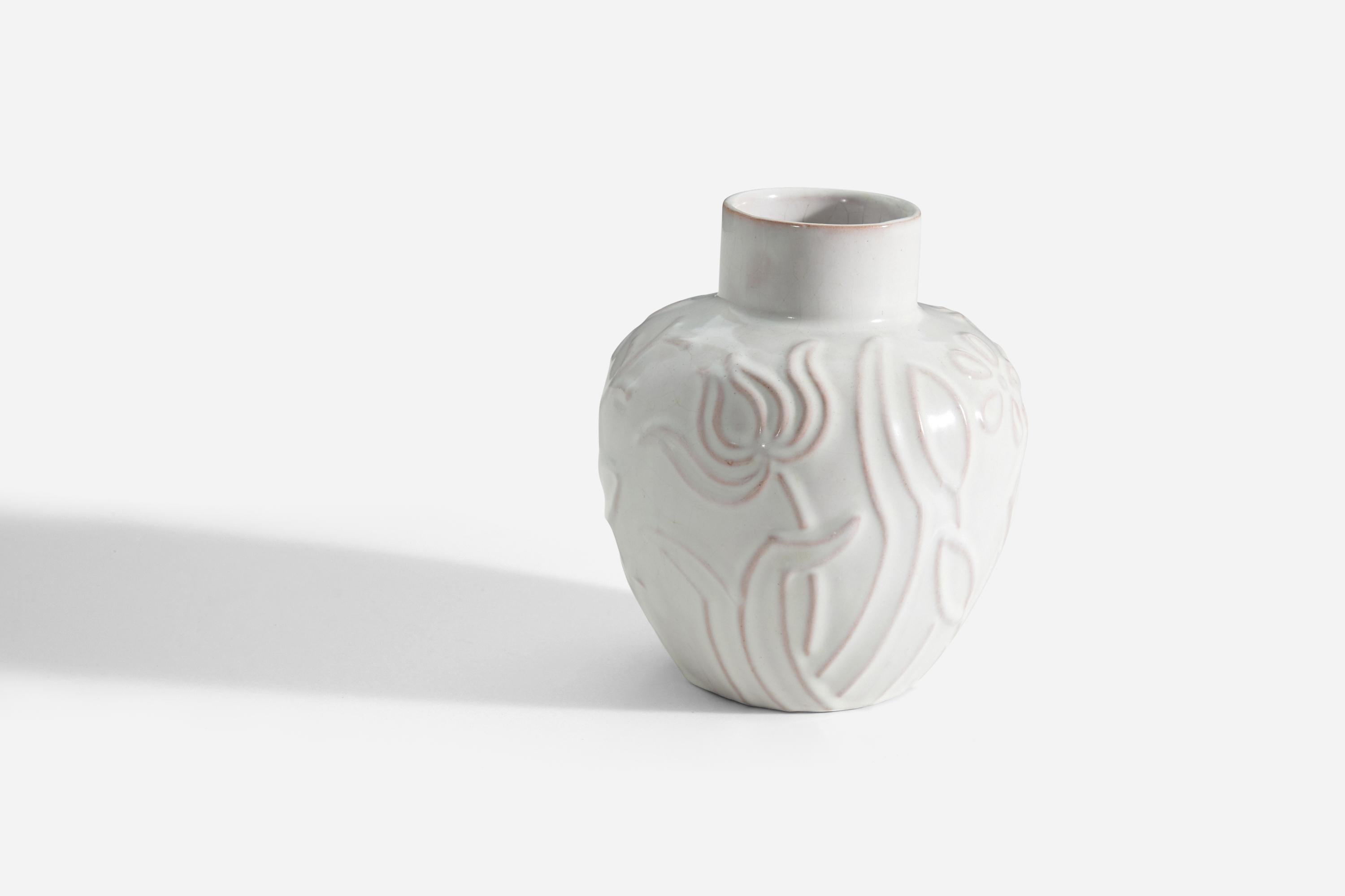 An early earthenware vase designed by Harald Östergren and produced by Upsala-Ekeby, Sweden, 1940s. The piece features a floral motif with white / cream glaze. 

