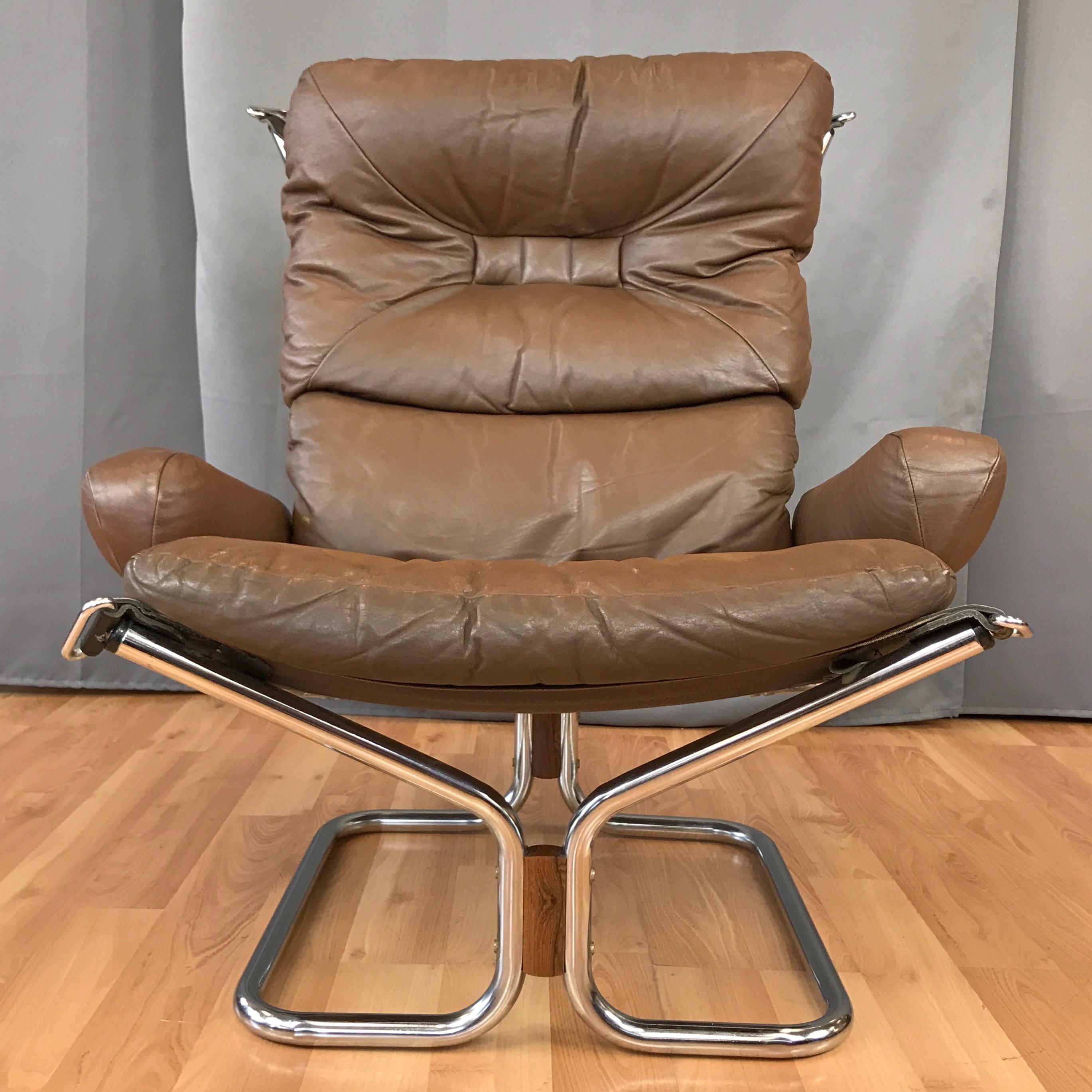 A 1970s leather and chrome “Wing” lounge chair by Harald Relling for Westnofa Furniture.

Supremely comfortable low-slung seat with high back and padded arms. Original brown leather upholstery with distinctively detailed down-filled tufted