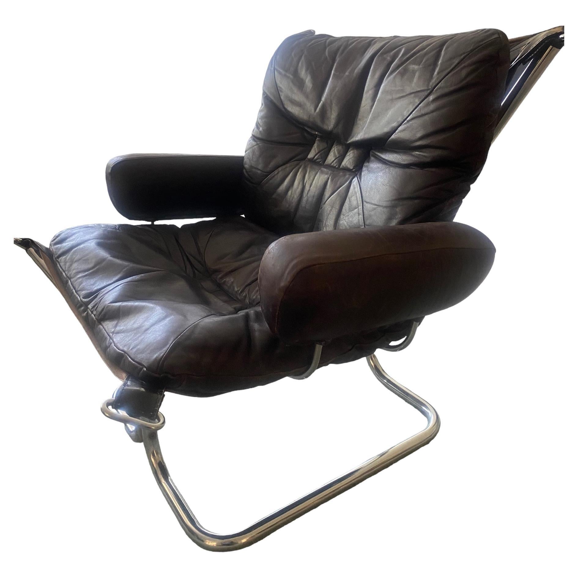 This slingback chair by Harald Relling stands out for its luxurious use of materials and fine attention to detail. The armrests are attached with a stitched leather eye and loop , almost like saddle joinery. The leather is soft aniline leather, and