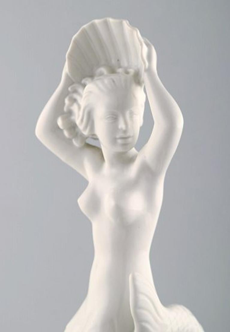 Harald Salomon for Rörstrand, Large and rare Blanc de Chine / white-glazed figure depicting mermaid with seashell on base.
Stamped.
In perfect condition.
1st factory quality.
Measures: 37 x 11 cm.