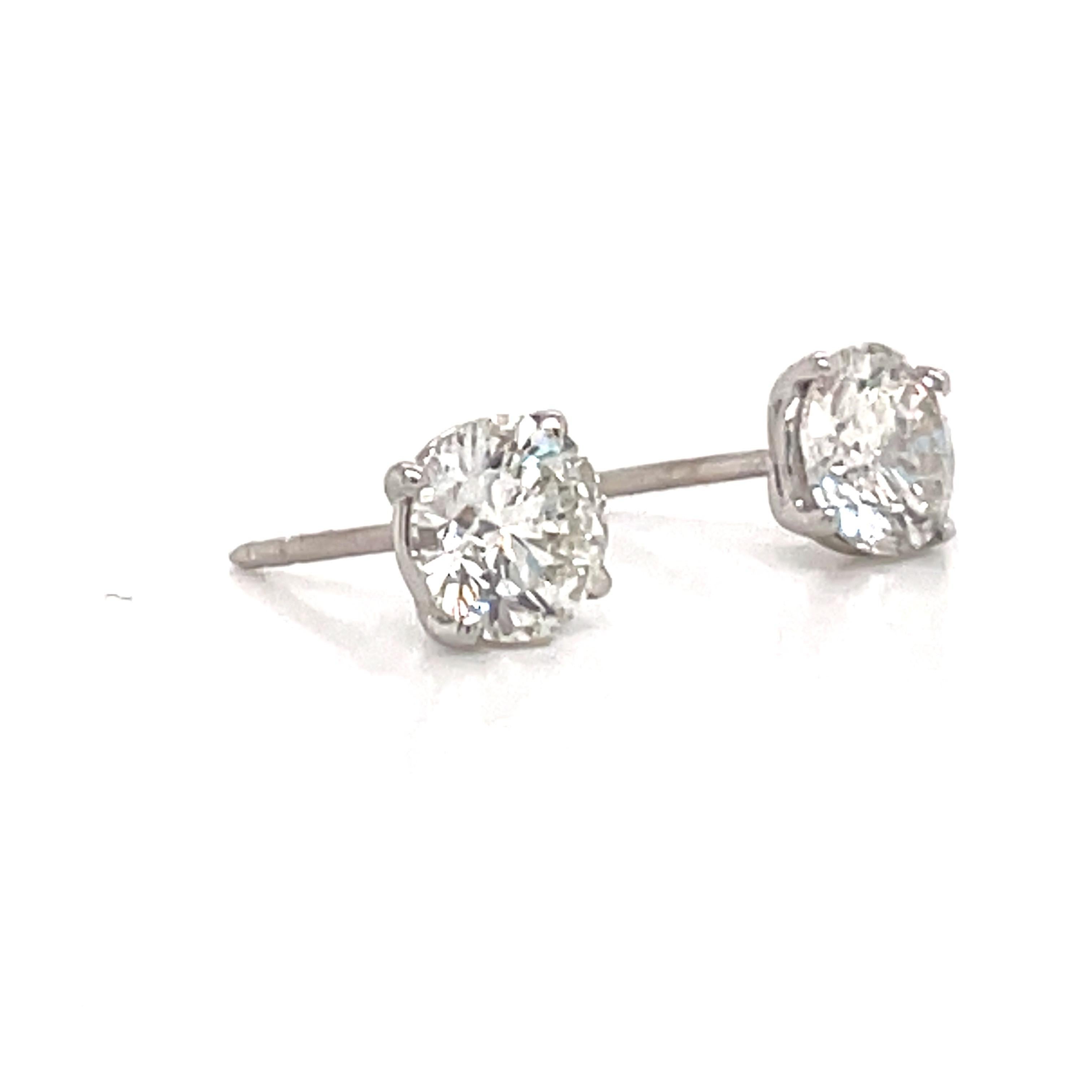 Diamond stud earrings weighing 2.29 carats in a 4 prong champagne setting, 18k white gold. 
Color H
Clarity I1