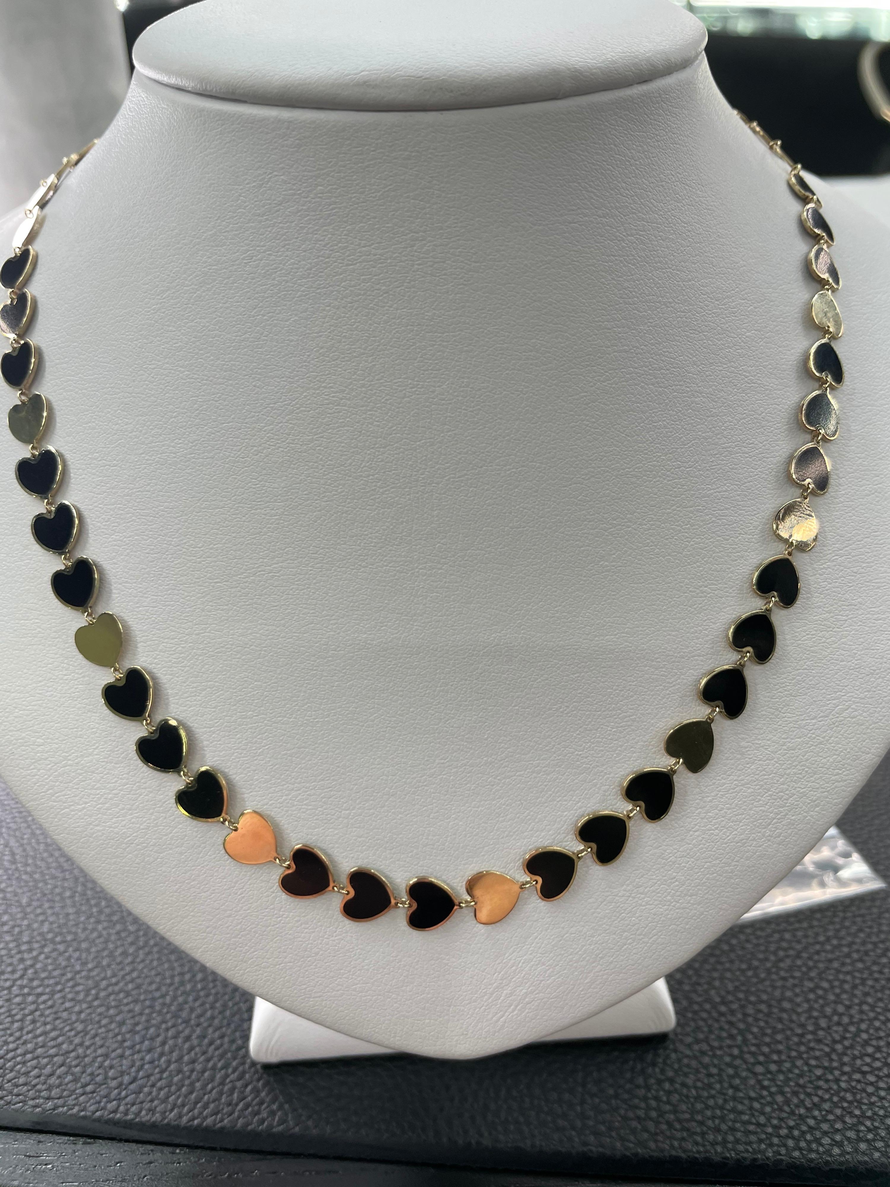 Italian 14k yellow gold necklace featuring onyx gold trim hearts and solid gold hearts. The necklace is 17.75 inches long and can be shortened to 15.5 inches. 9.5 Grams
Available in different colors. 

Can add a charm on the open heart link.